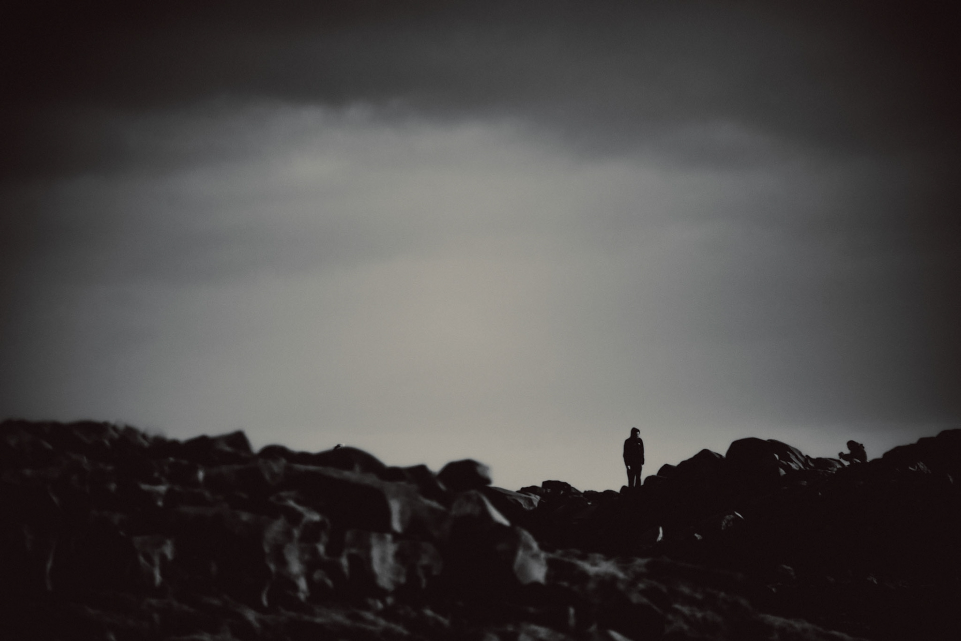 Two people taking adventure photos on a rocky ridge, Iceland, May 2016, Sony A7RII.