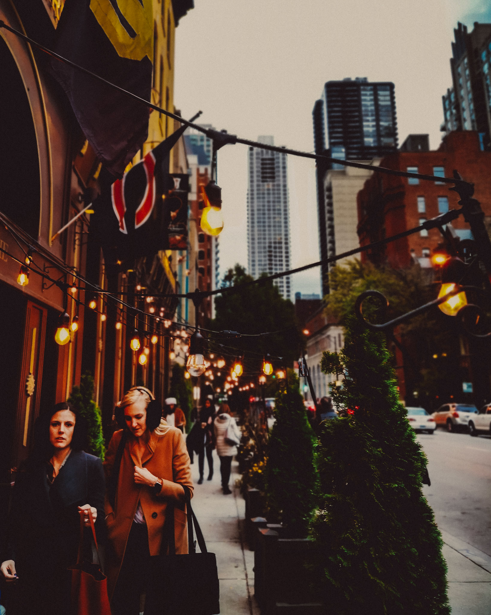 Two caucasian women walking outside Kerryman Irish Bar, Chicago, Illinois, USA, November 2019, Huawei P30 Pro.