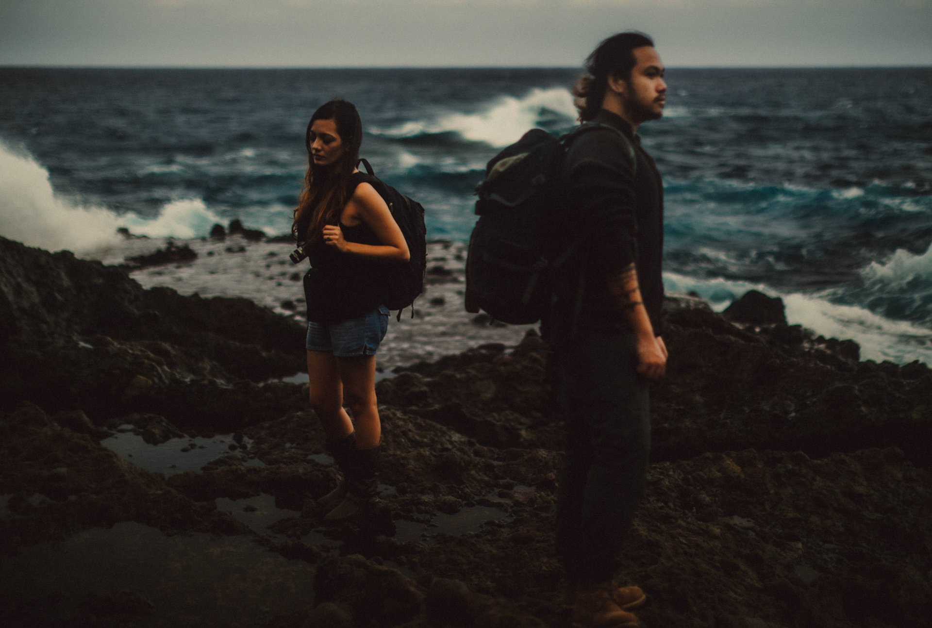 Moody backpacker couple portraits on a rocky coast below Chawa View Deck in Mahatao, Batanes, Philippines, Southeast Asia, November 2014, Canon EOS 6D.