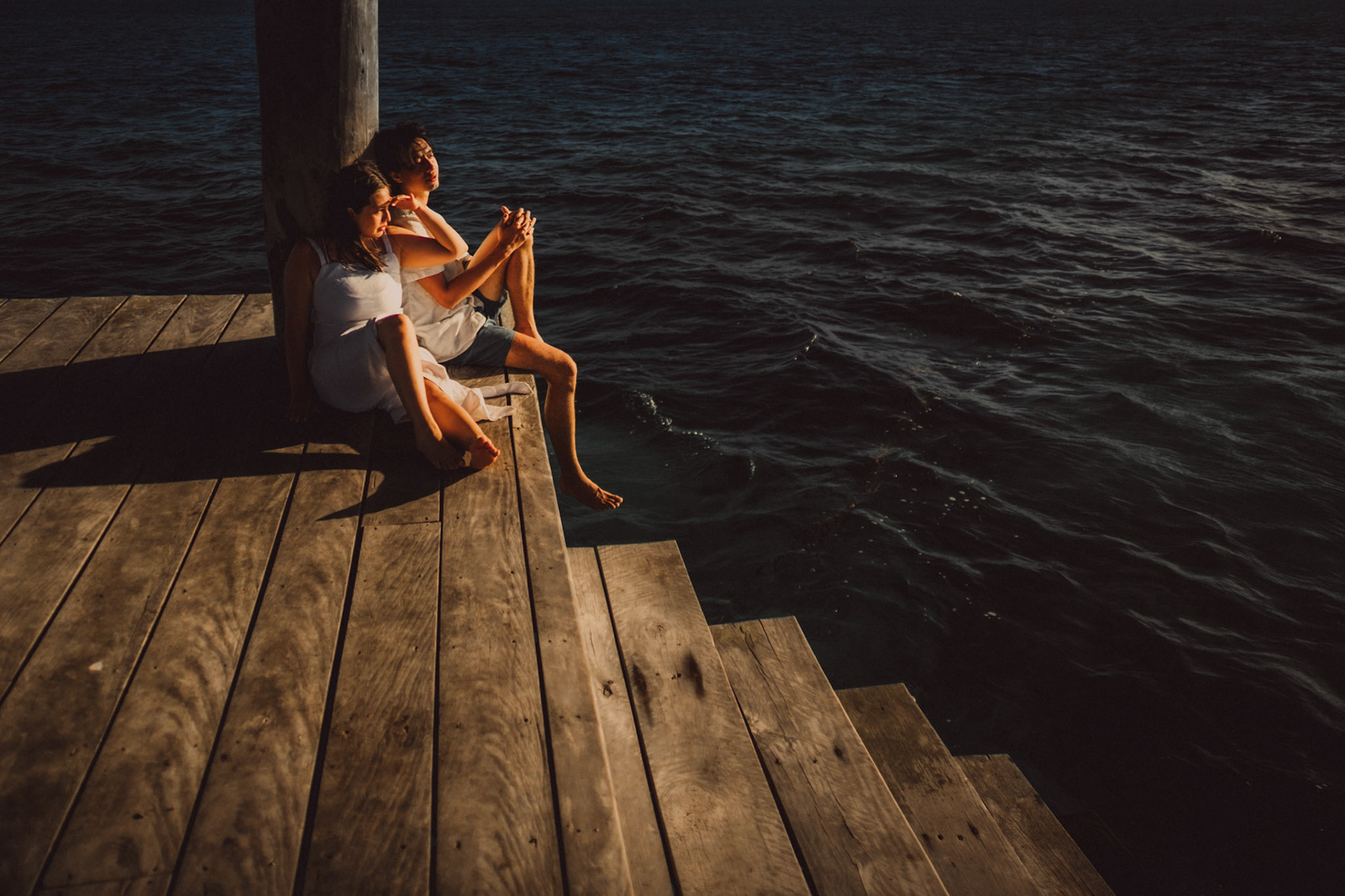 Moody newlywed portraits on Nay Palad Hideaway's floating pagoda in the middle of the sea, from Jeo and Bianca's island hopping honeymoon couple portrait shoot in Siargao Island, Philippines, Southeast Asia, February 2020, Sony A7III