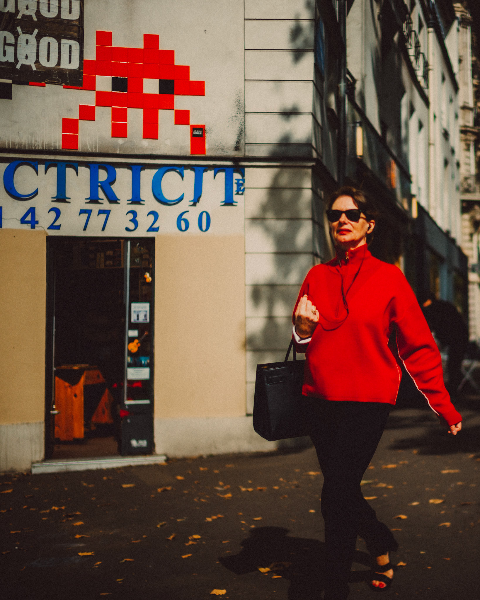 A woman wearing a red jacket walking along Boulevard Beaumarchais, Paris, France, September 2017, Leica M.