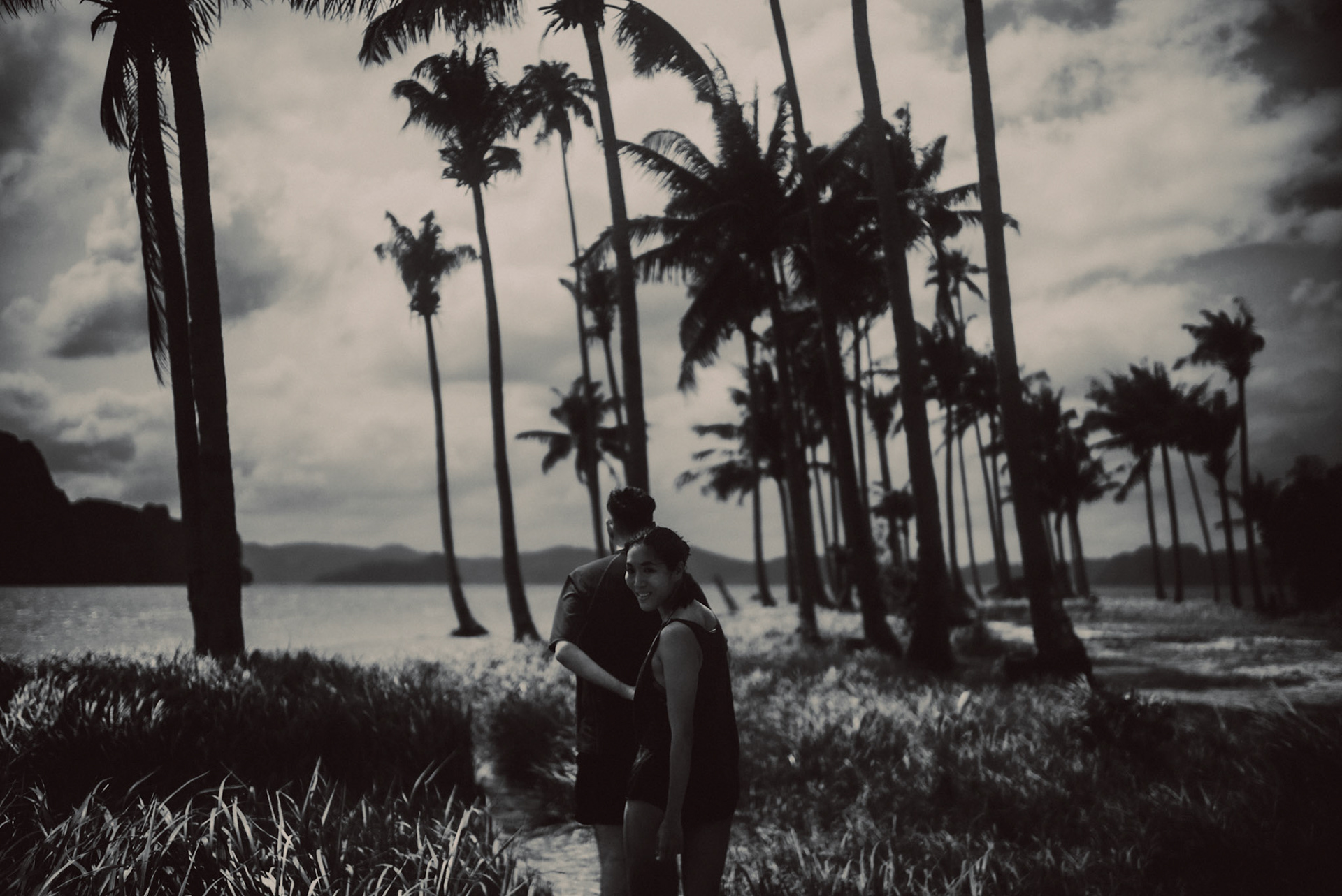 Moody island hopping couple portraits, in black and white, Pinagbuyutan Island, El Nido, Palawan, Philippines, Southeast Asia, January 2017, Leica M