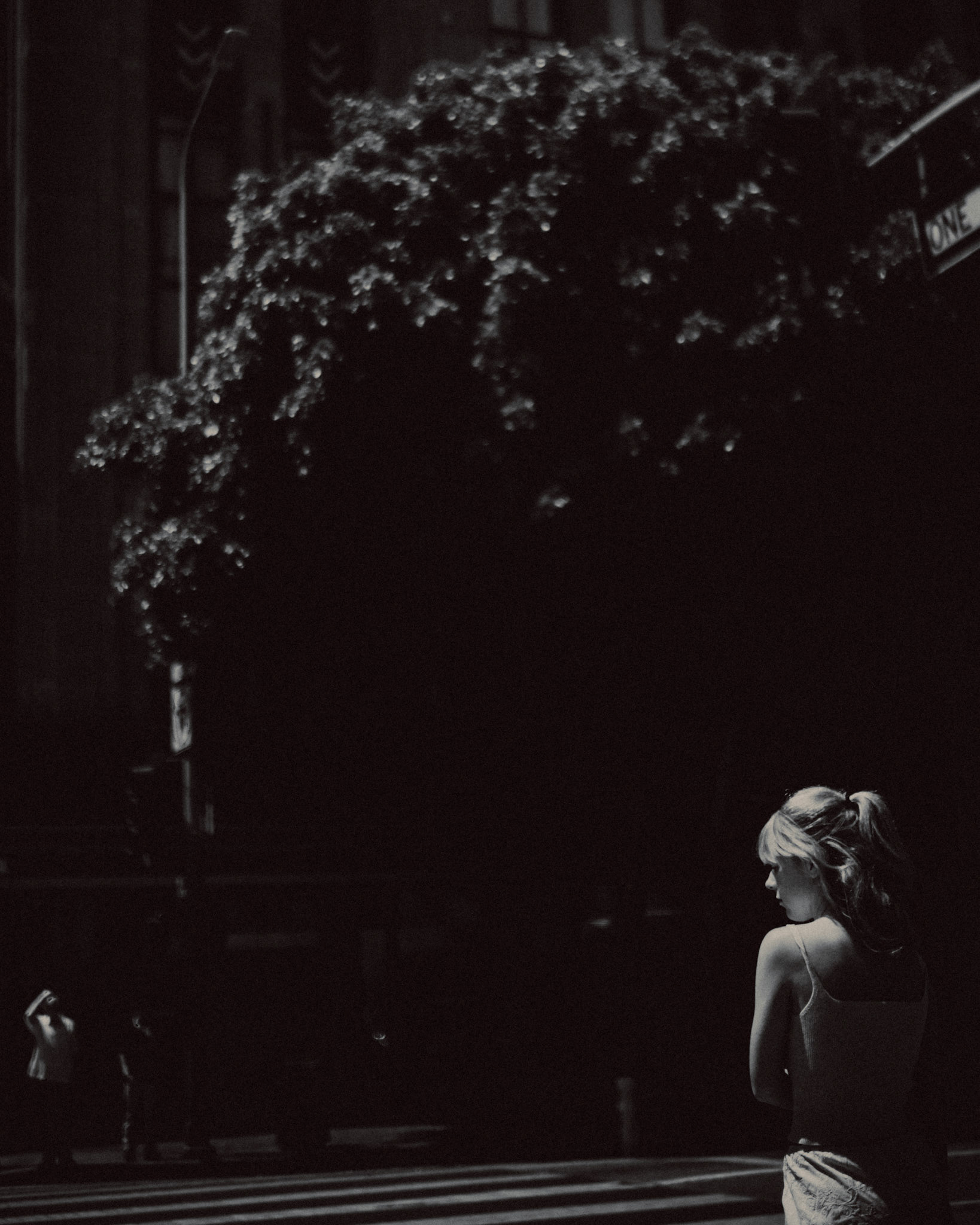 A woman at the S Broadway pedestrian crossing in Downtown LA, in black and white, Los Angeles, California, USA, July 2018, Leica M.