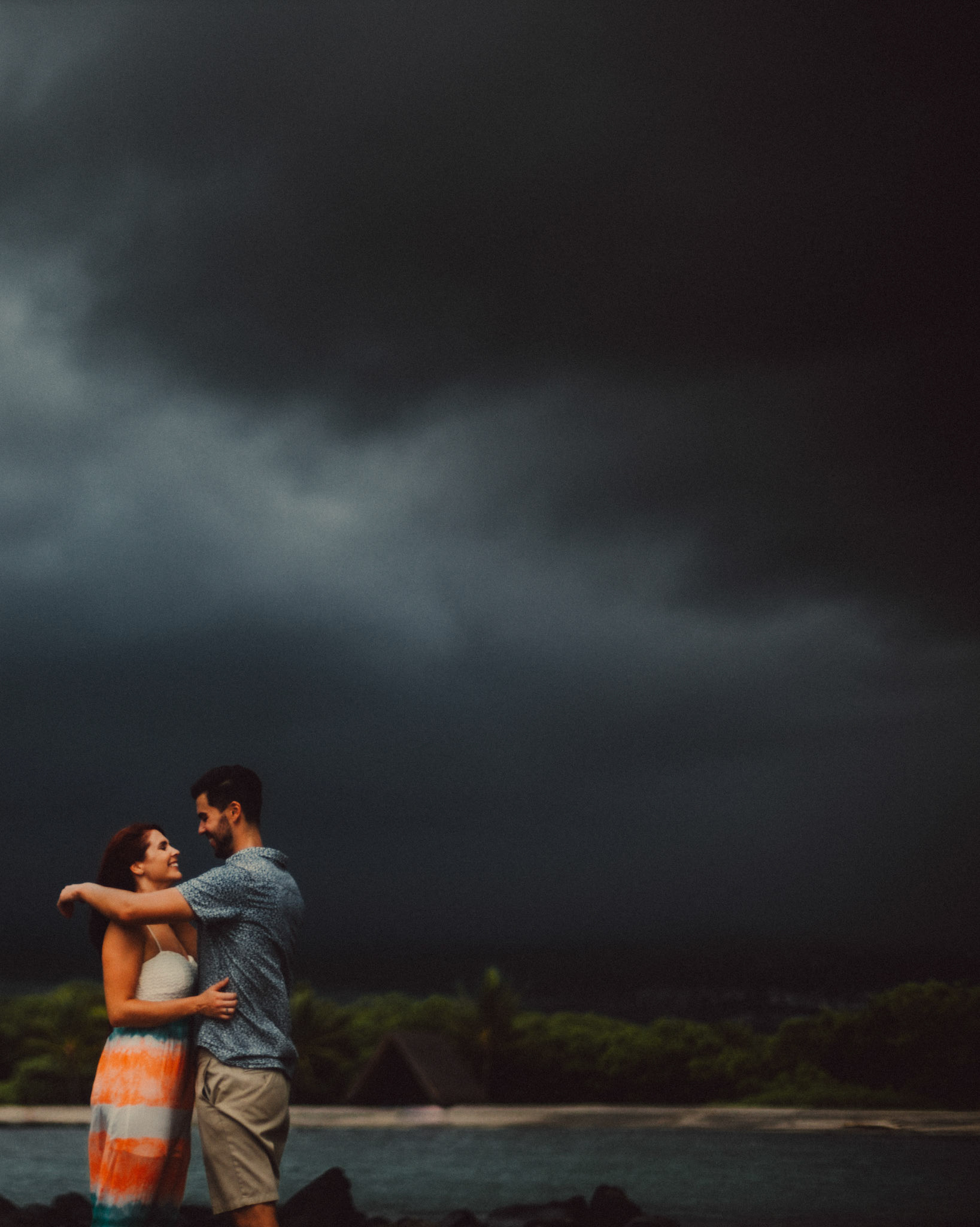 Stormy weather couple portraits at Honokohau Beach, from Ryan and Angela's engagement shoot in Hawaii, USA, September 2015, Sony A7S.