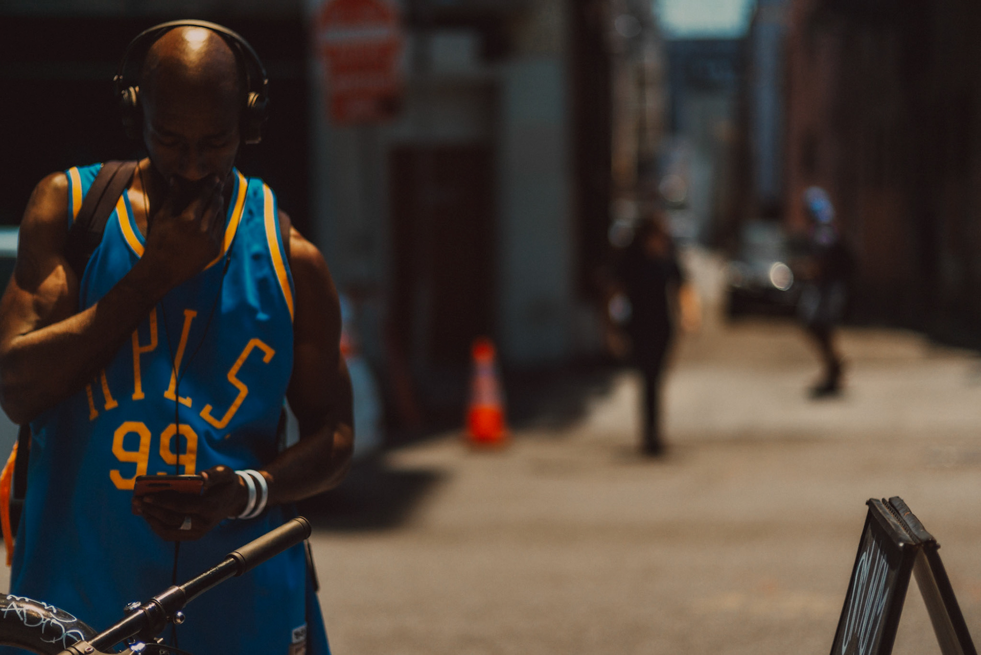 A man in a brighly-colored basketball jersey, Los Angeles, California, USA, July 2018, Leica M.