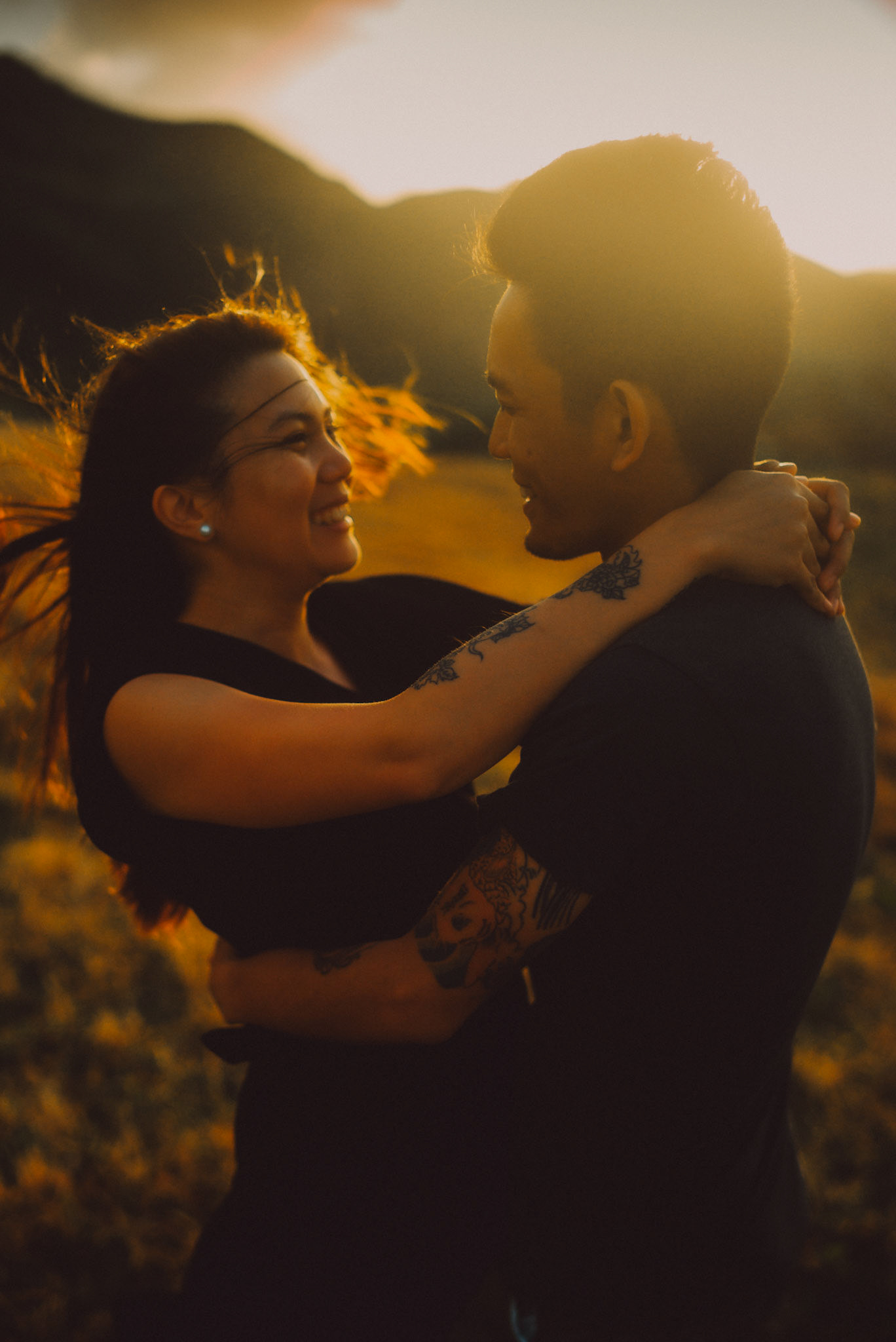 Intimate couple portraits on a seaside cliff just moments before sunset, from Owen and Nikka's adventure prenup photoshoot in Chadpidan Boulder Beach, Batanes, Philippines, Southeast Asia, October 2017, Leica M.