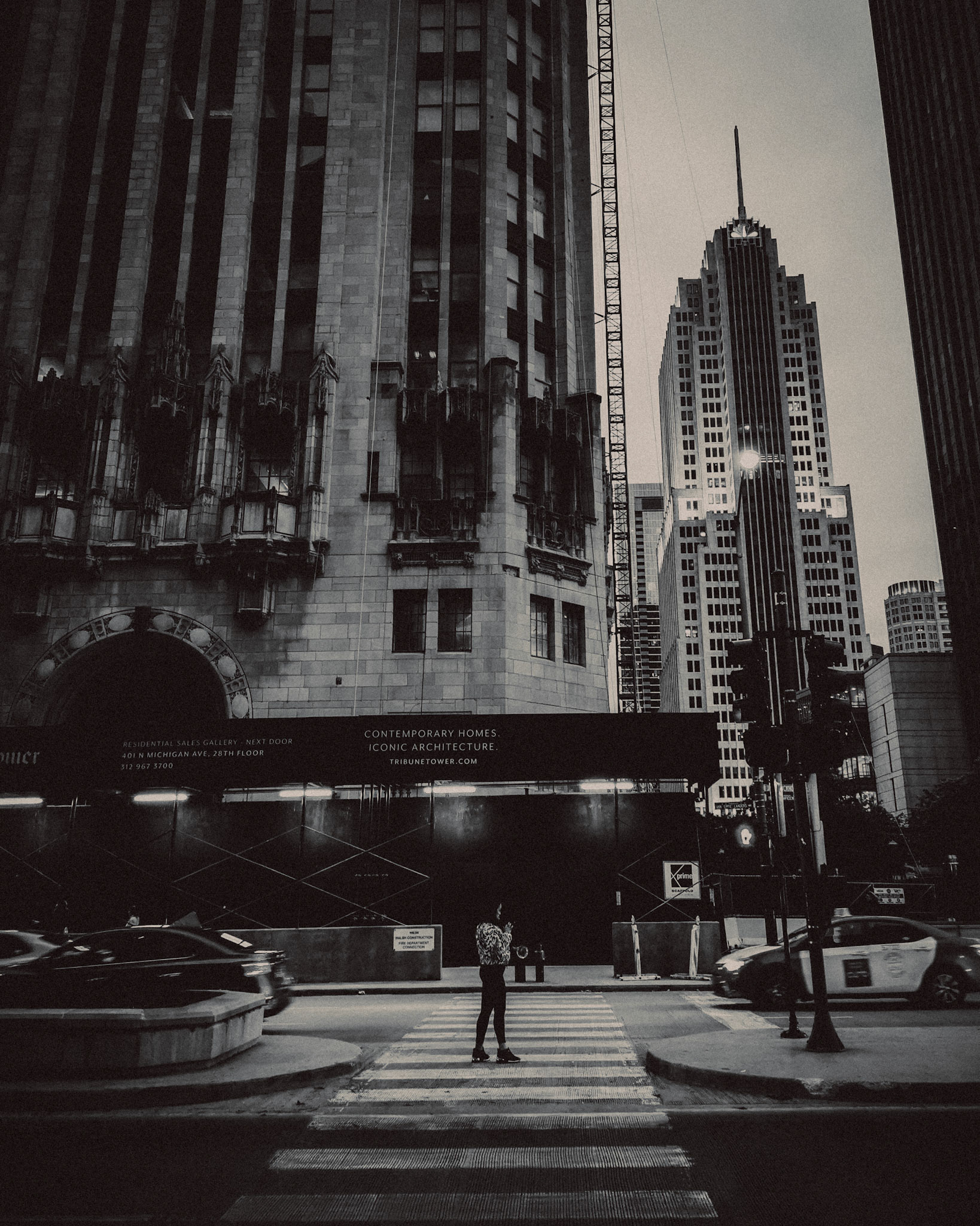 A woman crossing Michigan Avenue, in black and white, Chicago, Illinois, USA, November 2019, Huawei P30 Pro.