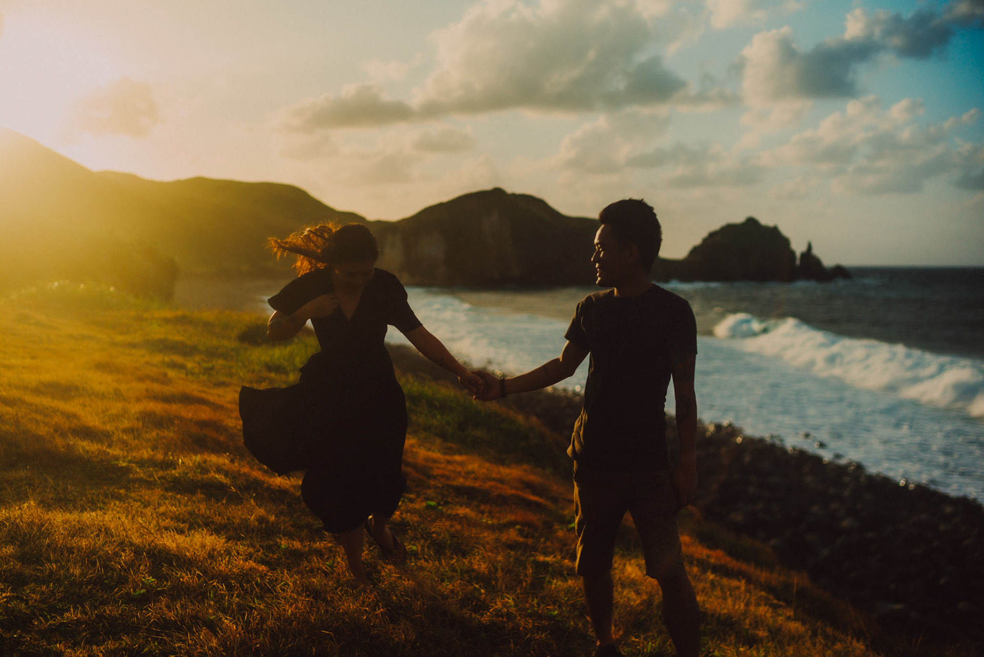 Cinematic sunset couple portraits on a seaside cliff, from Owen and Nikka's adventure prenup photoshoot in Chadpidan Boulder Beach, Batanes, Philippines, Southeast Asia, October 2017, Leica M.