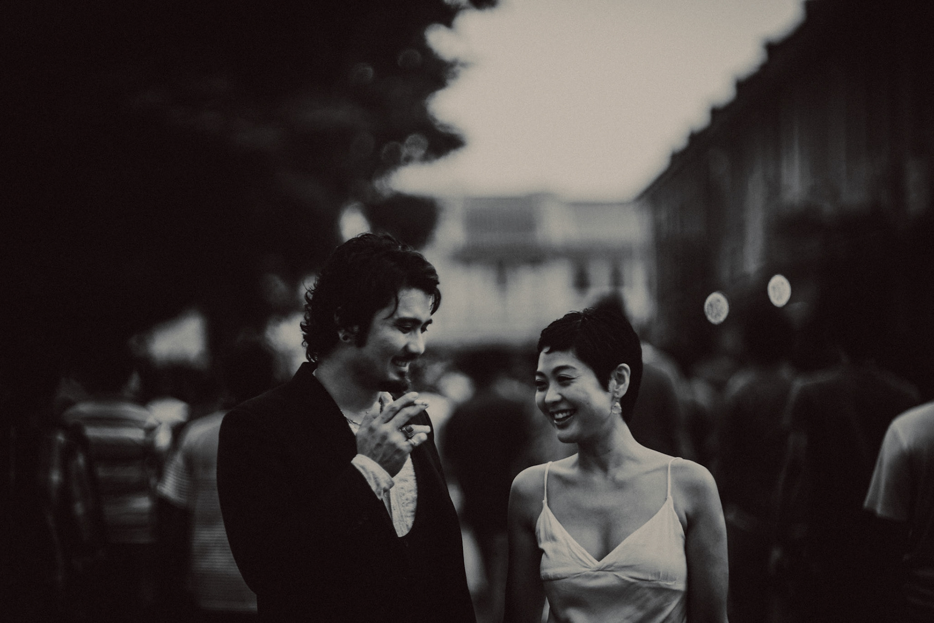 A candid, reportage-style engagement shoot in Little India on a Sunday afternoon feauring a Japanese couple, in black and white, Farrer Park, Singapore, October 2015, Sony A7S.