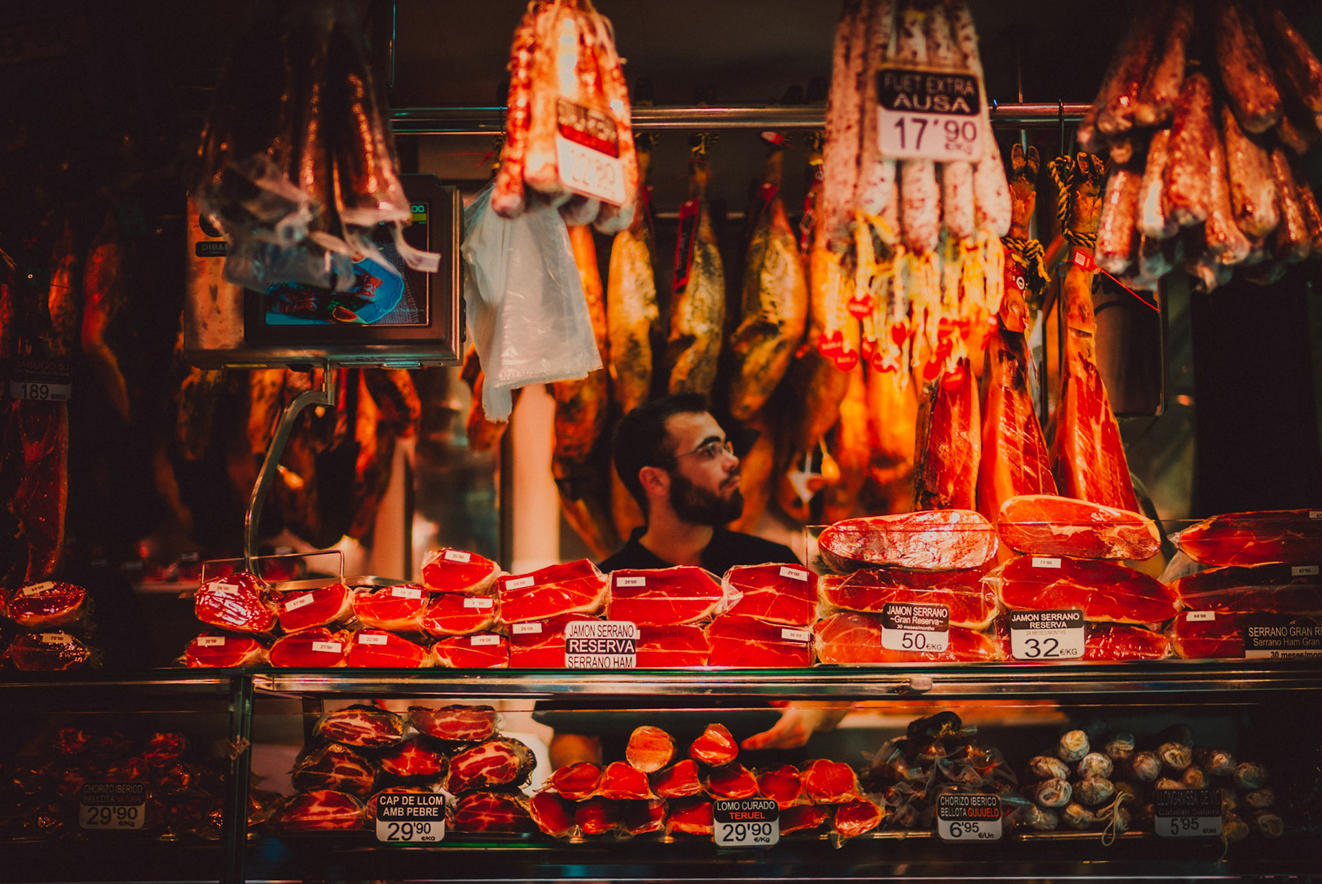 A shopkeeper selling cured meat in Mercat de la Boqueria, Barcelona, Spain, July 2016, Leica M.
