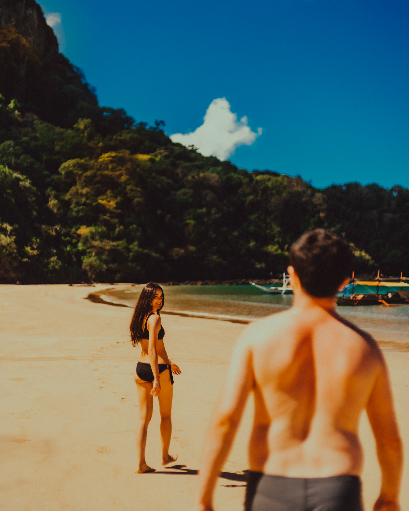 A travel couple on an island hopping tour of a virgin tropical beach in Cadlao Island, El Nido, Palawan, Philippines, Southeast Asia, March 2020, Sony A7III.