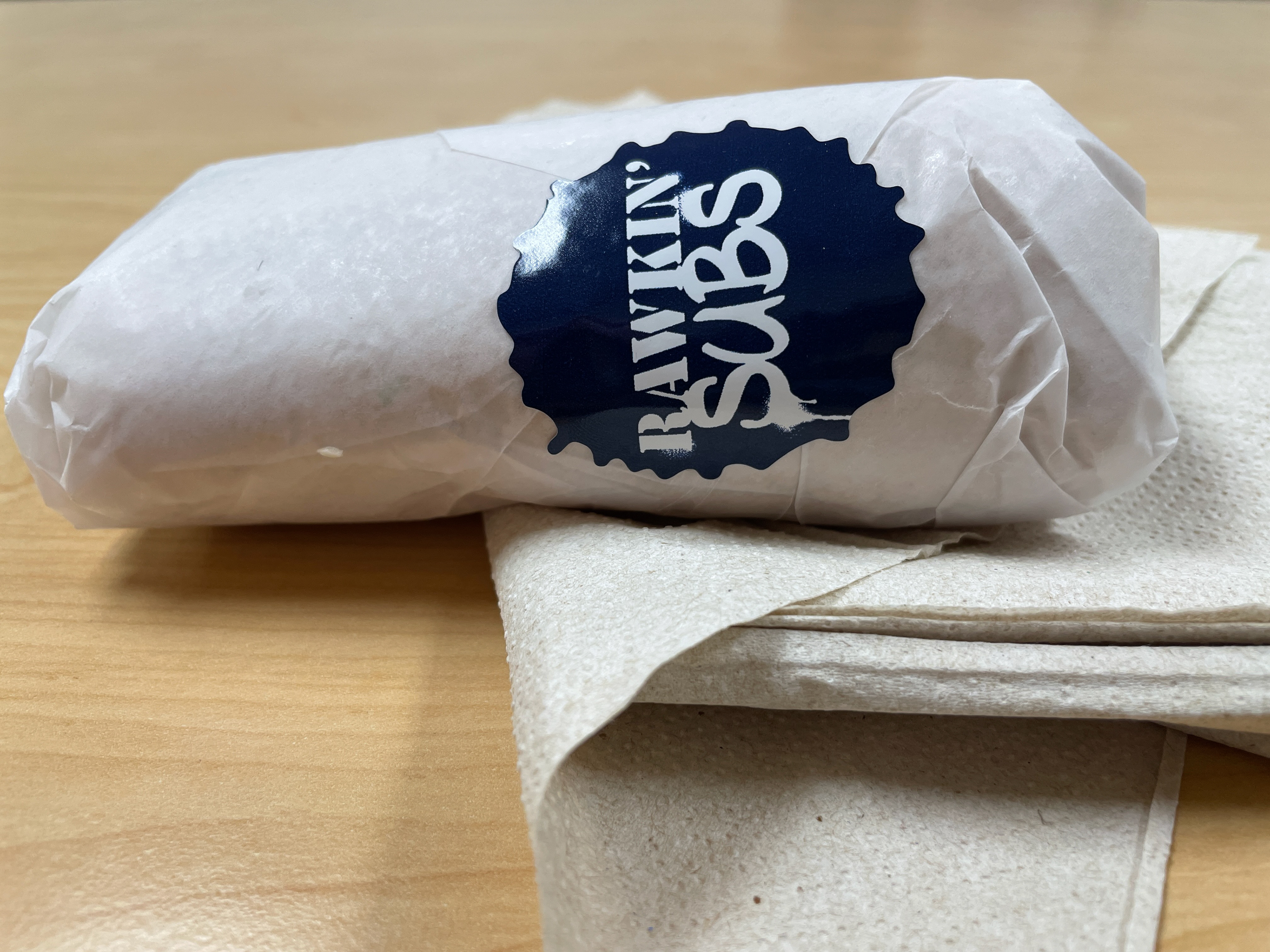 Wrapped sandwich with sticker.