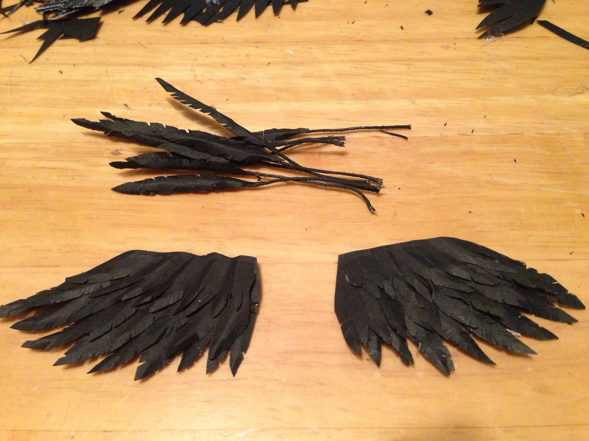 Step 3: Layer the paper wings and individual feather pieces