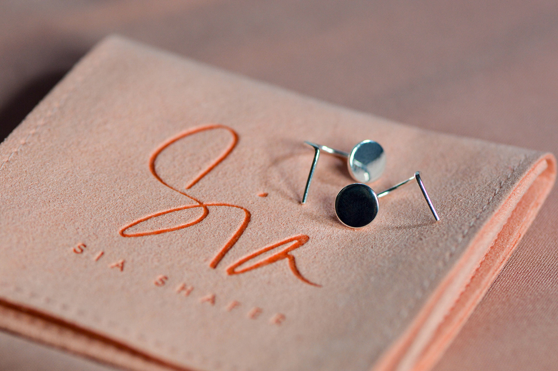 Silver earrings on branded packaging for Sia Shafer - creative jewellery photographer