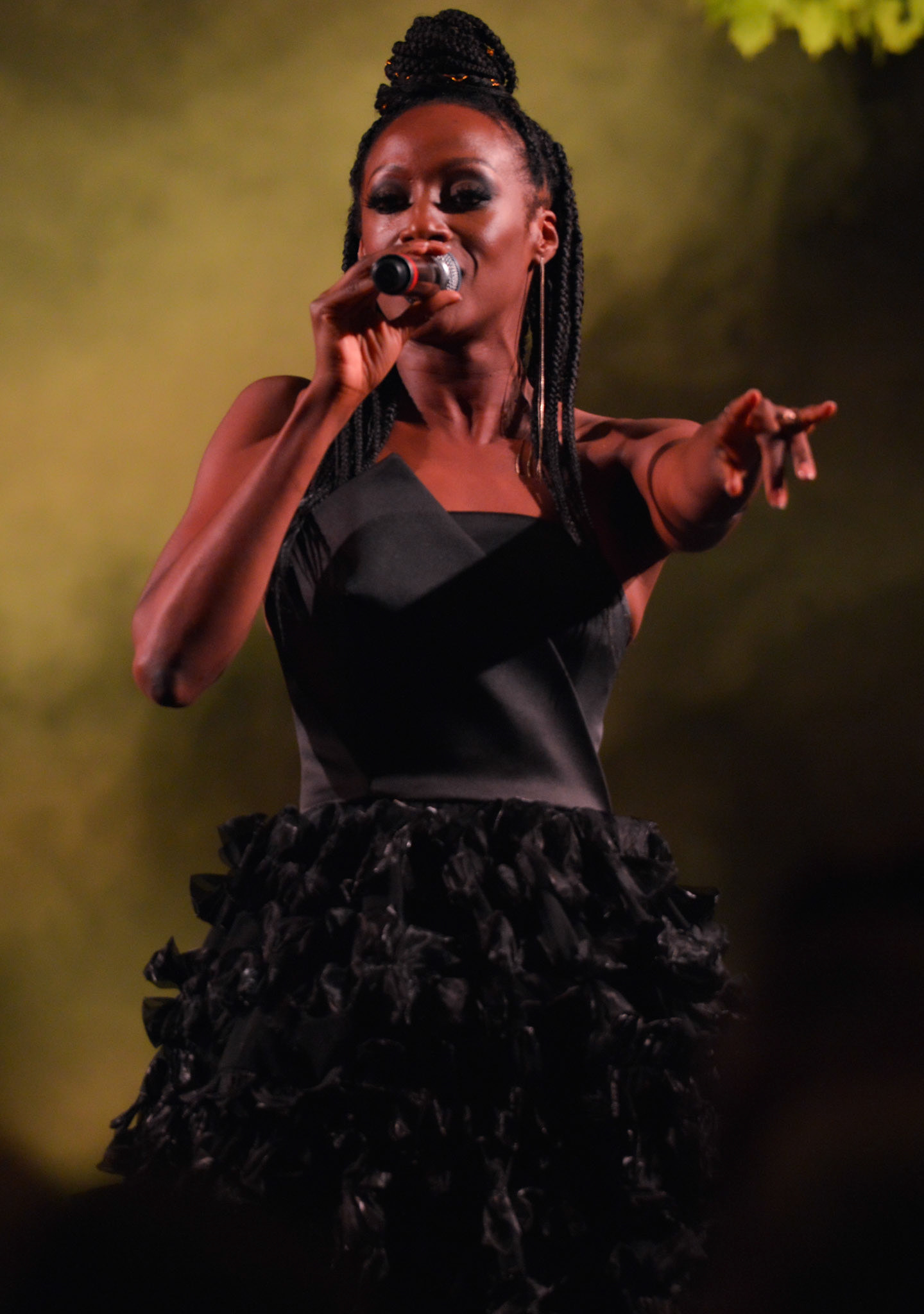 Victoria Ekanoye singing on stage at the 2019 Manchester Fashion Festival - Runway Photographer