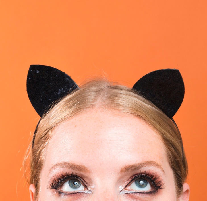 lindsey l ahmet graphic designer and photographer halloween marketing blog image of women peering over with cat ears on