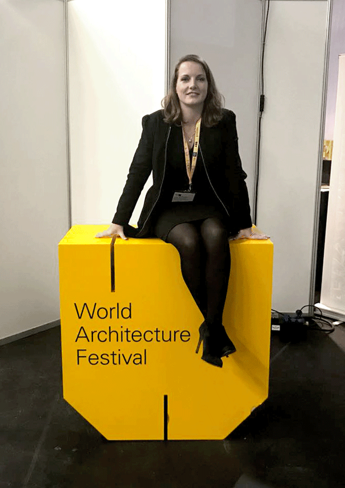 Janneke Eggink posing on the World Architecture Festival (WAF) sign