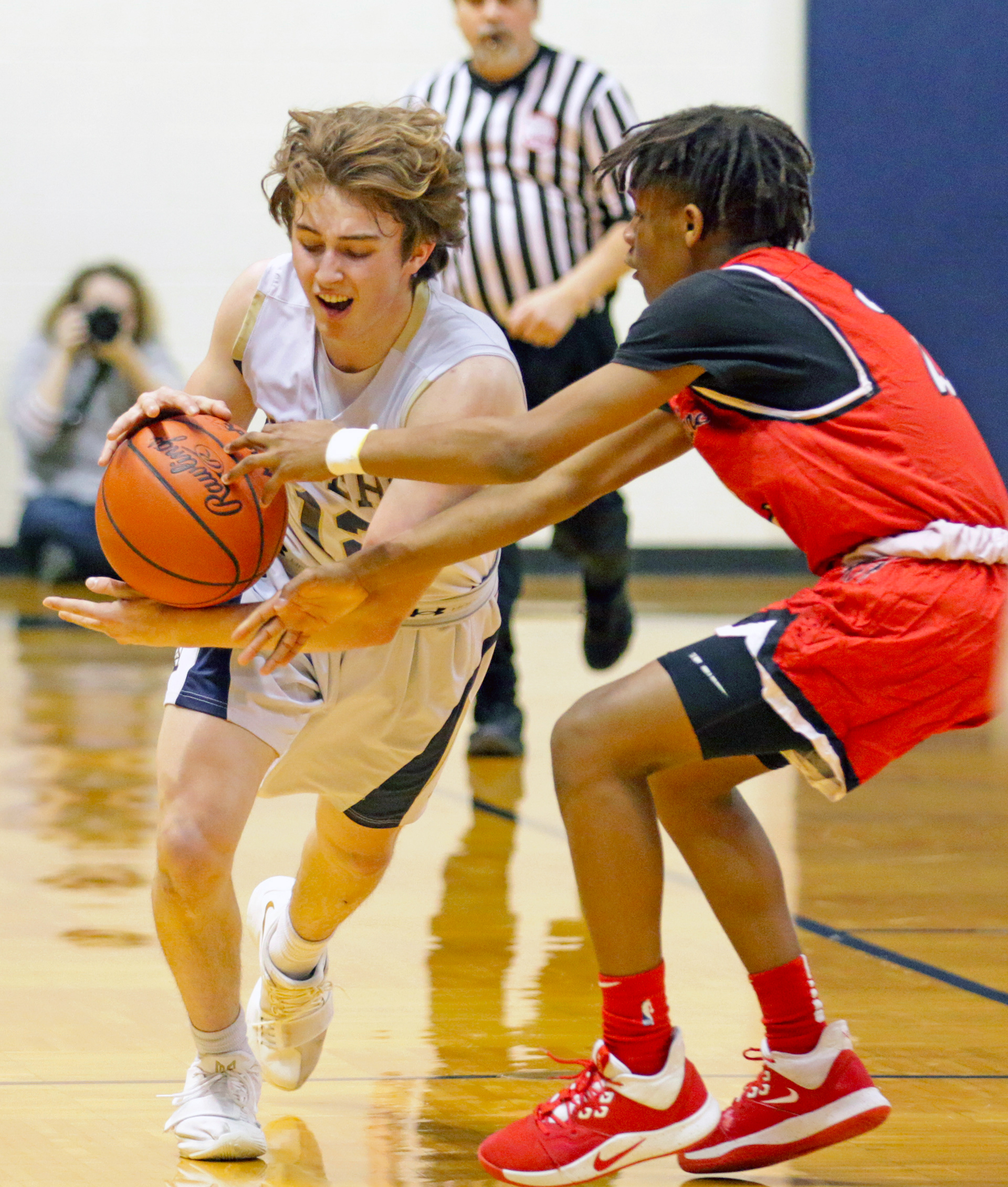 Ryan McIntyre, 12, plays for Mt. Pleasant High School pushes through Julian Freeman, 2, from Grand Blanc and heads to the net during the Junior Varsity game at Mt. Pleasant High School in Mt. Pleasant on February 27, 2020.
