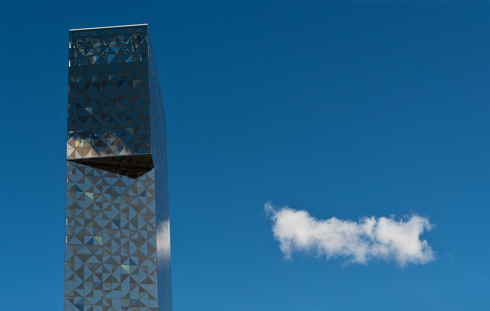 Scandic Viktoria Tower with a solitary lonely cloud alongside it.