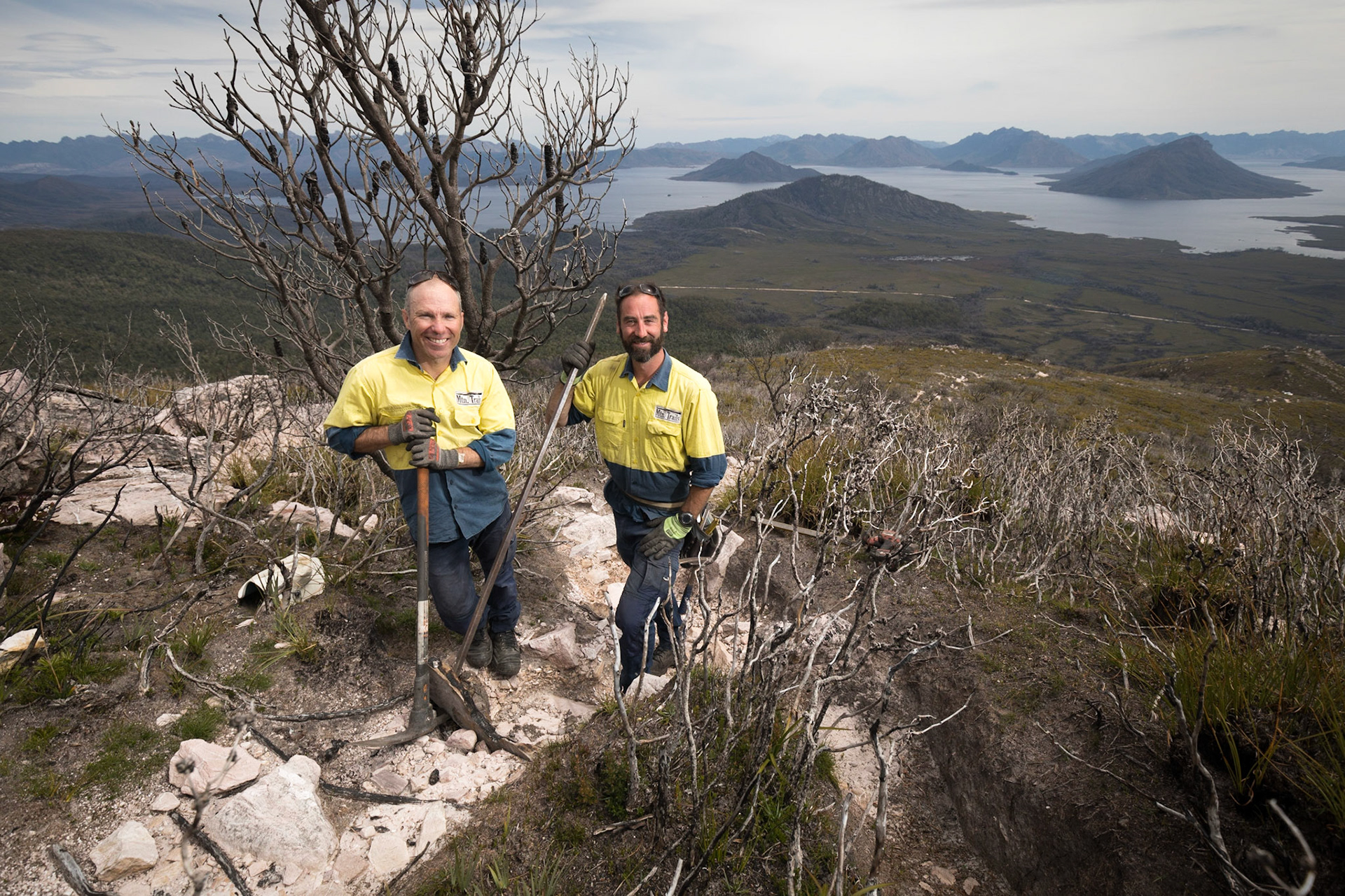 Track builders Dan Roe and Cam Sweeney of Mtn.Trails a Tasmanian specialist trail building company working on the Mount Anne Circuit track overlooking Lake Pedder in the south west of Tasmania.  The track was completely burnt out  in the 2018/2019 bushfires.
