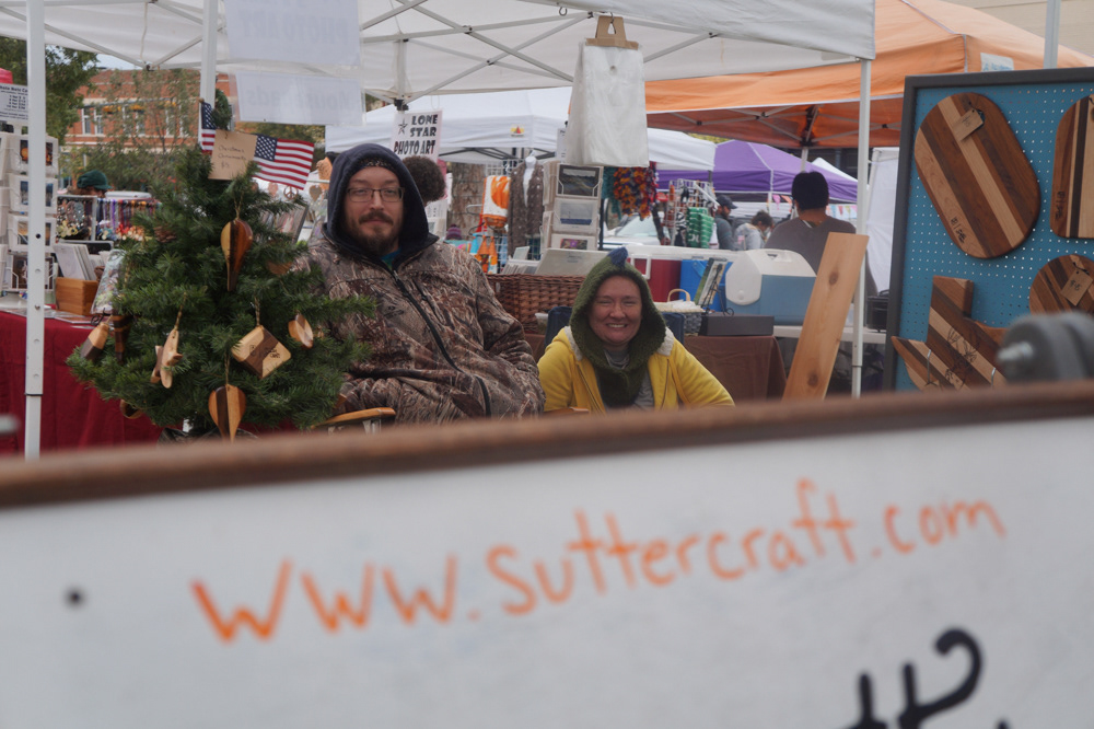 Patrick and Chrissy Page-Sutter pose for a portrait in their woodworking shop.