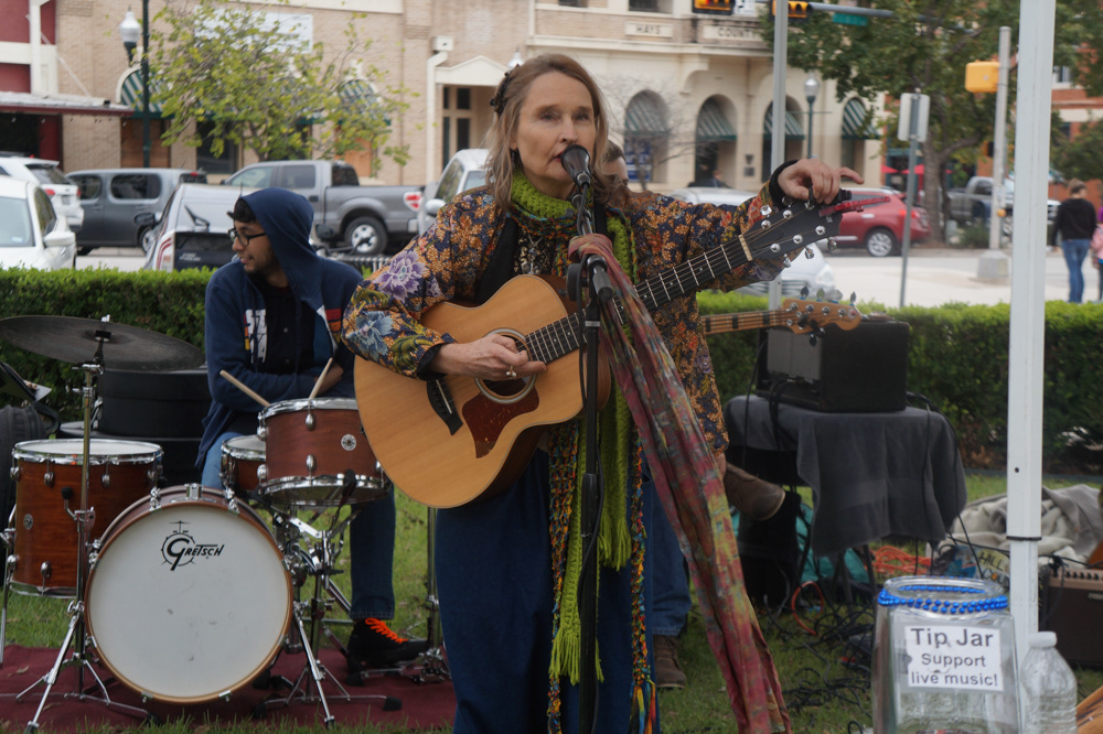 MariLisa Swain tunes her guitar before the band plays another song.