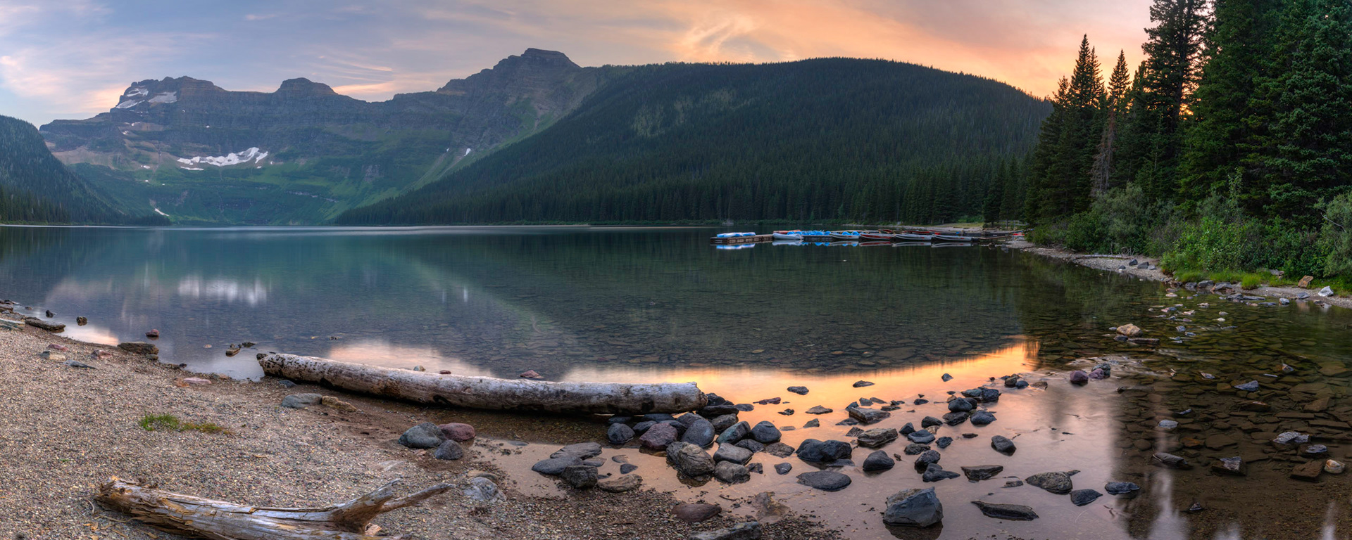 A bit of a smoky sunset at Cameron Lake, on the southern border of Alberta Canada.  The peaks at the far end of the lake are in Glacier National Park, Montana, United States.Waterton Lakes National ParkAugust 1, 2015This is an HDR panoramic image consisting of 7 frames comprised of 5 exposures each. HDR processing performed in Photomatix Pro.  Panoramic stitching performed in Photoshop. Additional processing performed in Lightroom and Photoshop.PENTAX K-3, Sigma 10-20mm f/4-5.6 EX DCISO 100 20 mm  2.0 sec at ƒ / 11