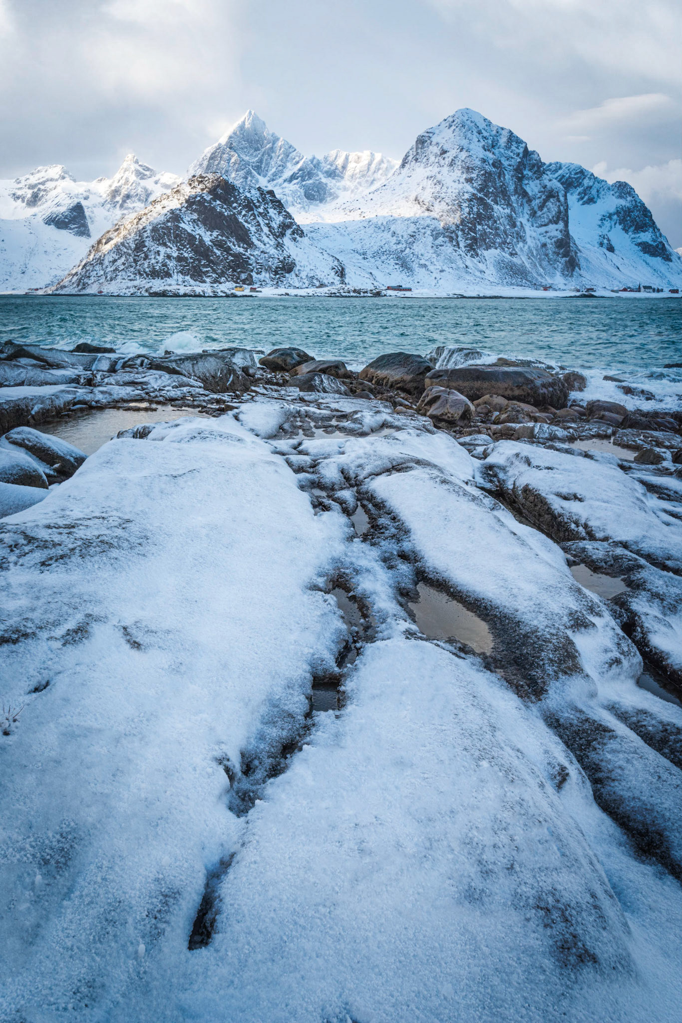 The rocky shoreline along Vareidsundet, leading into Flakstadtinden and Stortinden.Vareid, Nordland, NorwayMarch 19, 2018Pentax K-1, HD PENTAX-D FA 15-30mm F2.8ED SDM WRISO 400 30 mm  ¹⁄₁₀₀ sec at ƒ / 16