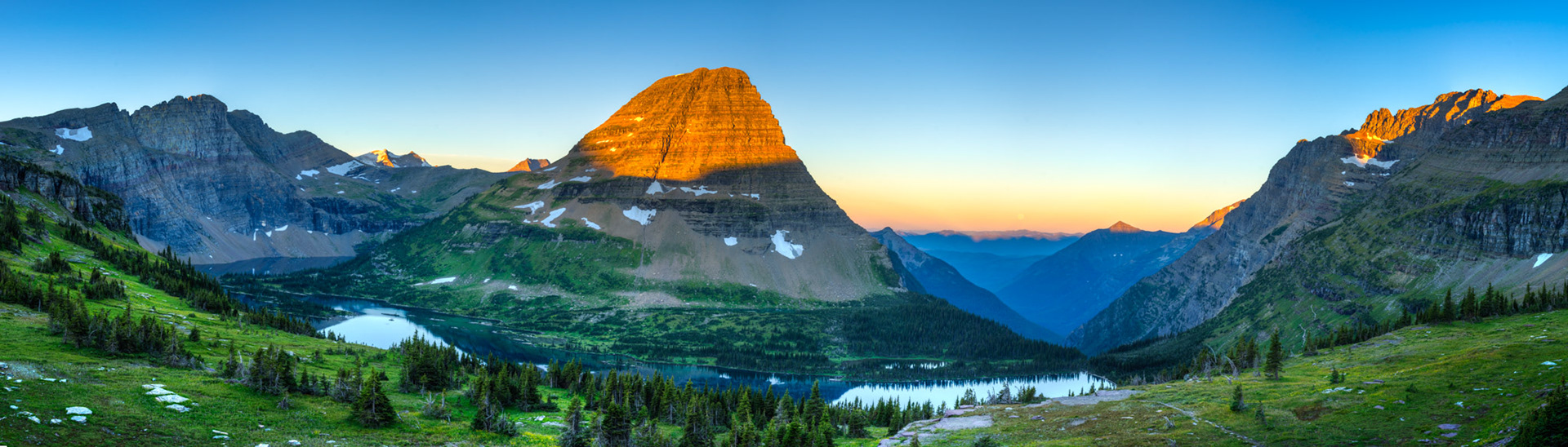 Rays of the rising sun striking the tops of Gunsight Mountain, Bearhat Mountain, Mount Stanton, and Mount Cannon, just as the full moon is setting.From the Hidden Lake overlook, above Logan Pass.Glacier National ParkJuly 31, 2015This is an HDR panoramic image consisting of 8 frames comprised of 5 exposures each. HDR processing performed in Photomatix Pro.  Panoramic stitching performed in Photoshop. Additional processing performed in Lightroom and Photoshop.PENTAX K-3, Sigma 18-250mm f/3.5-6.3 DC OS HSMISO 100 28 mm  ¹⁄₁₅ sec at ƒ / 11