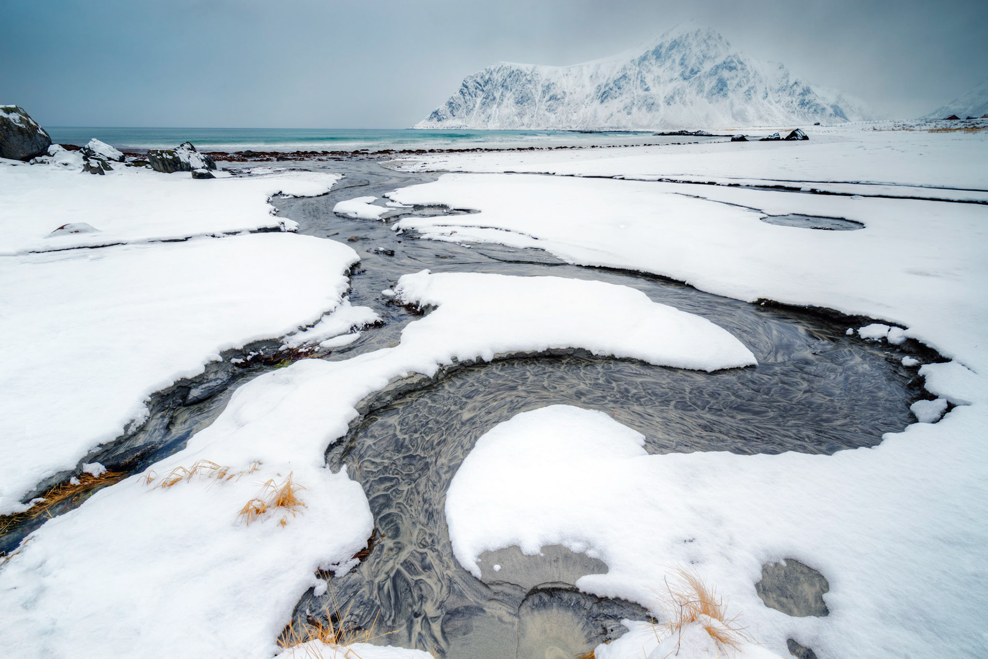 Skagsanden Beach, where minerals in the streams create ever-changing patterns of black and grey.   It's also one of the more popular beaches in Lofoten for surfing year-round.Flakstad, Nordland, NorwayMarch 20, 2018PENTAX K-1, HD PENTAX-D FA 15-30mm F2.8ED SDM WRISO 100 15 mm  ¹⁄₂₀ sec at ƒ / 16