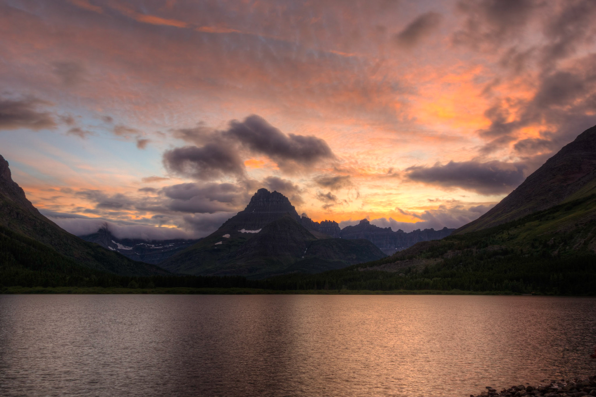 Sunset at Swiftcurrent Lake, near the Many Glacier Hotel.Glacier National ParkJuly 27, 2015This is an HDR image consisting of 5 exposures merged in Photomatix Pro. Additional processing in Lightroom and Photoshop.PENTAX K-3, Sigma 18-250mm f/3.5-6.3 DC OS HSMISO 100 18 mm  ¹⁄₁₅ sec at ƒ / 11