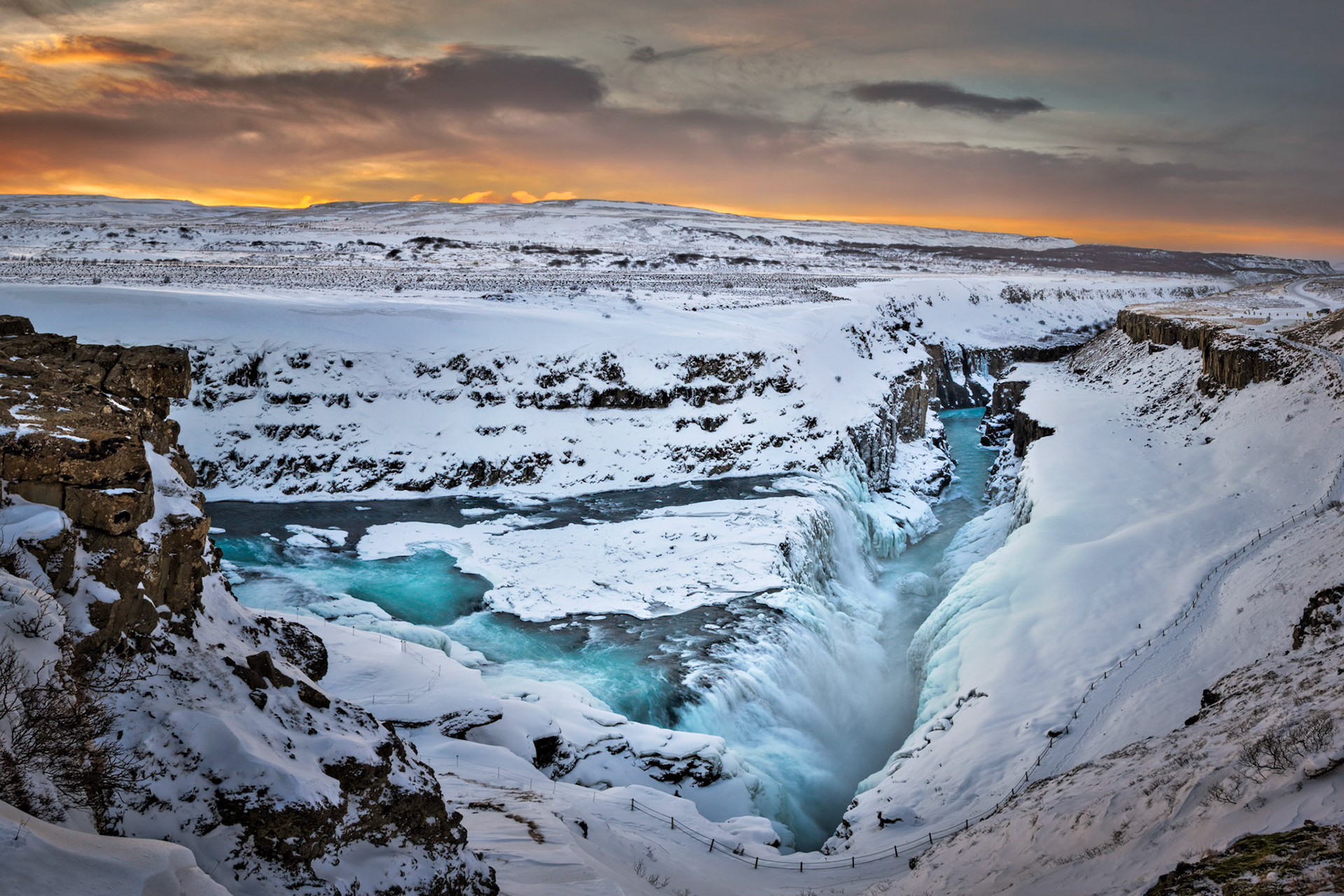 The lower section of Gullfoss, at sunrise.  With ~40mph sustained winds.Suðerland, IcelandFebruary 8, 2016This is an HDR panoramic image consisting of 4 frames comprised of 5 exposures each. HDR processing performed in Photomatix Pro.  Panoramic stitching performed in Photoshop. Additional processing performed in Lightroom and Photoshop.PENTAX K-3, Sigma 18-250mm f/3.5-6.3 DC OS HSMISO 800 18 mm  ¹⁄₅₀ sec at ƒ / 9.0