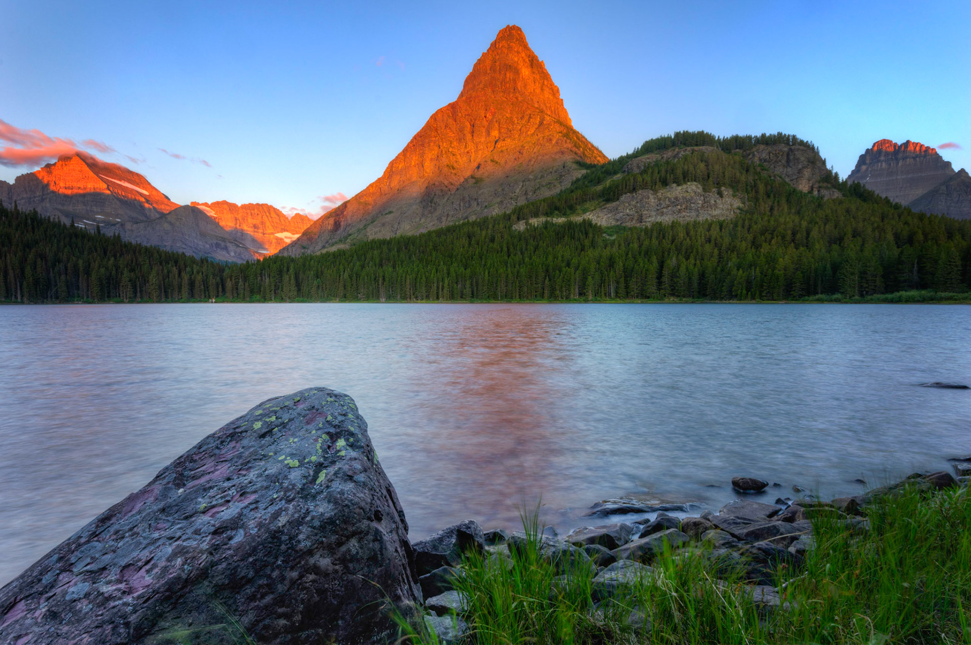 Alpenglow on Grinnell Point and the surrounding mountains, from the shore of Swiftcurrent Lake.Glacier National ParkJuly 29, 2015This is an HDR image consisting of 5 exposures merged in Photomatix Pro. Additional processing in Lightroom and Photoshop.PENTAX K-3, Sigma 10-20mm f/4-5.6 EX DCISO 100 14 mm  0.8 sec at ƒ / 16