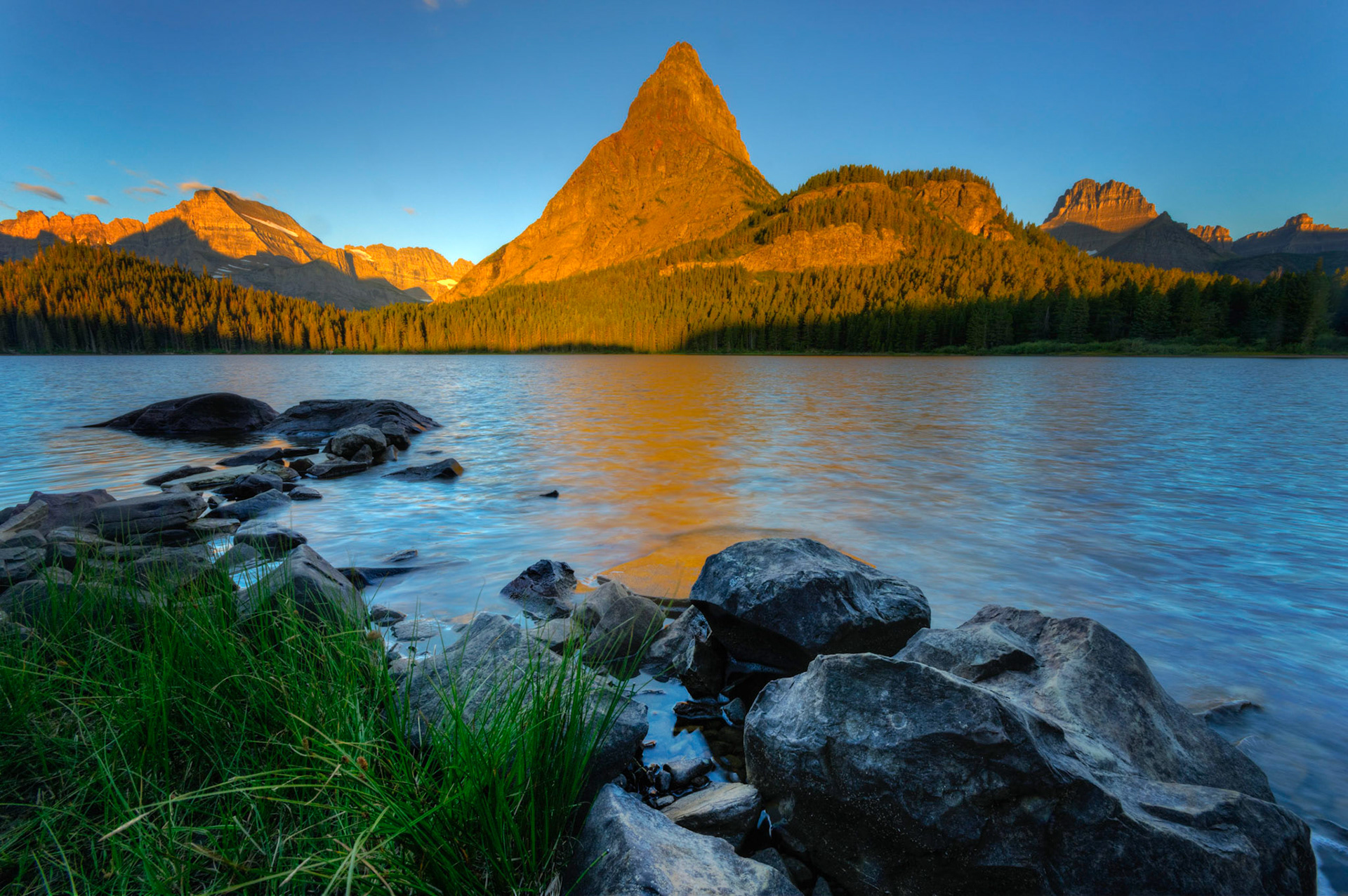 Early morning sunlight on the peaks to the west of Switfcurrent Lake.Glacier National ParkJuly 29, 2015This is an HDR image consisting of 5 exposures merged in Photomatix Pro. Additional processing in Lightroom and Photoshop.PENTAX K-3, Sigma 10-20mm f/4-5.6 EX DCISO 100 10 mm  ⅕ sec at ƒ / 16