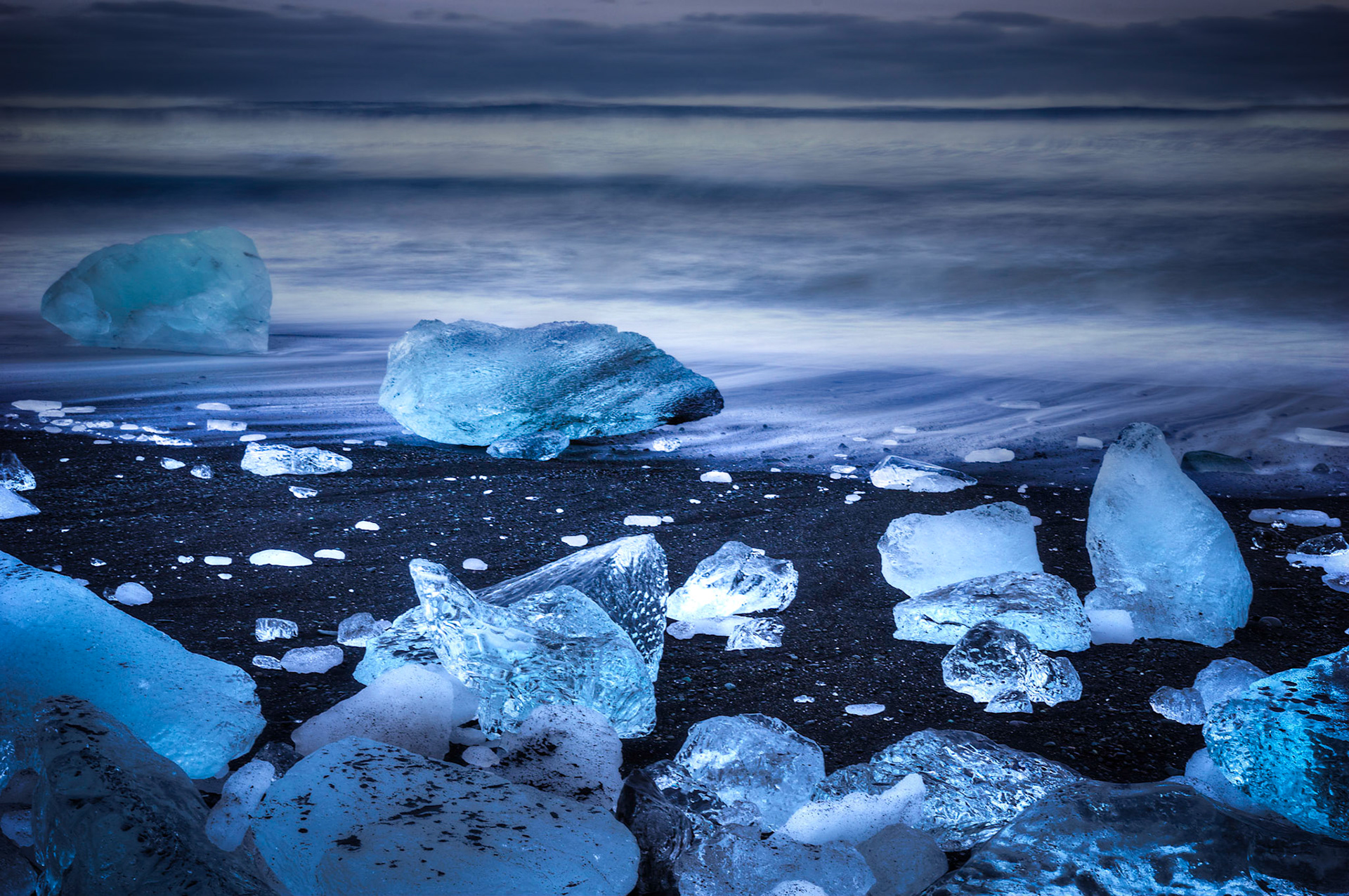 Ice boulders surrounded by windblown sand and snow on the beach near Jökulsárlón, after sunset.Austurland, IcelandFebruary 1, 2016This is an HDR image consisting of 3 exposures merged in Photomatix Pro. Additional processing in Lightroom and Photoshop.PENTAX K-3, SIGMA 18-35mm F1.8 DC HSM A013ISO 100 35 mm  13.0 sec at ƒ / 14