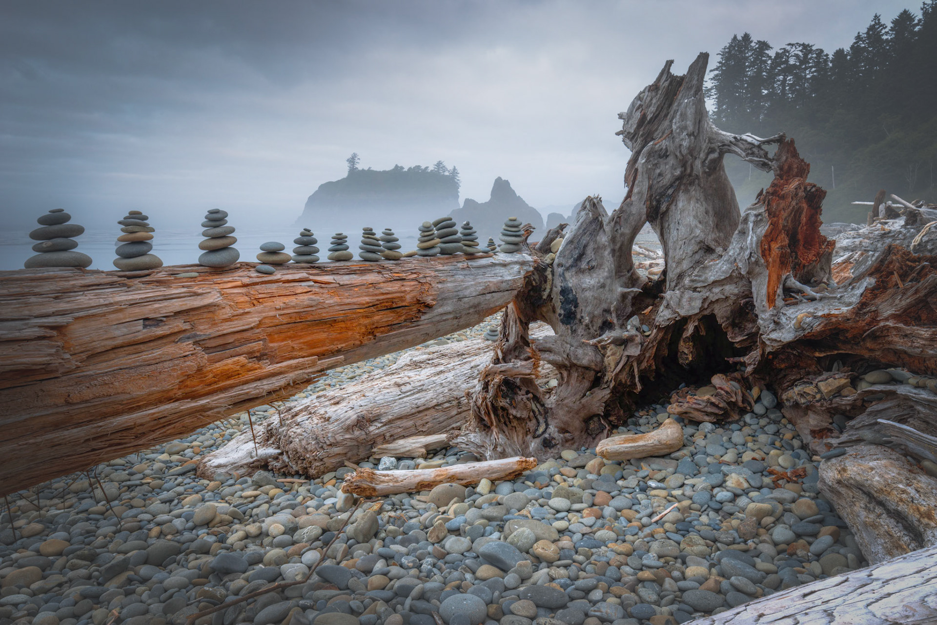 Small stone cairns piled on driftwood along Ruby Beach, near Kalaloch, Washington.Olympic National ParkWashingtonAugust 3, 2016This is an HDR image consisting of 5 exposures merged in Photomatix Pro. Additional processing in Lightroom and Photoshop.PENTAX K-1, HD PENTAX-D FA 15-30mm F2.8ED SDM WRISO 100 24 mm  0.6 sec at ƒ / 22