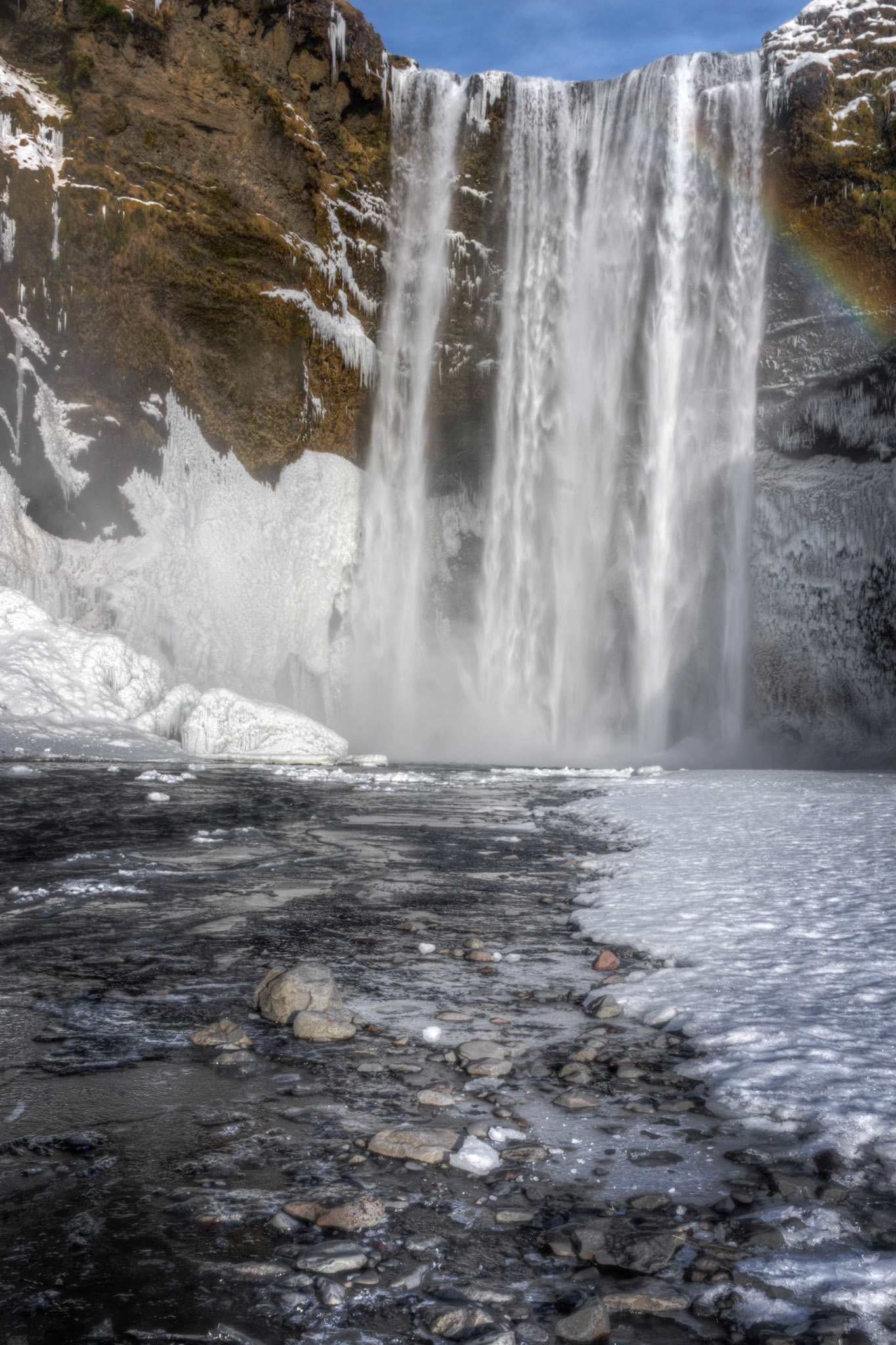 Falls of the Skógá River, as it descends from between Eyjafjallajökull and Mýrdalsjökull.South, IcelandFebruary 8, 2016This is an HDR image consisting of 5 exposures merged in Photomatix Pro. Additional processing in Lightroom and Photoshop.PENTAX K-3, Sigma 18-250mm f/3.5-6.3 DC OS HSMISO 100 21 mm  ¹⁄₁₃ sec at ƒ / 18