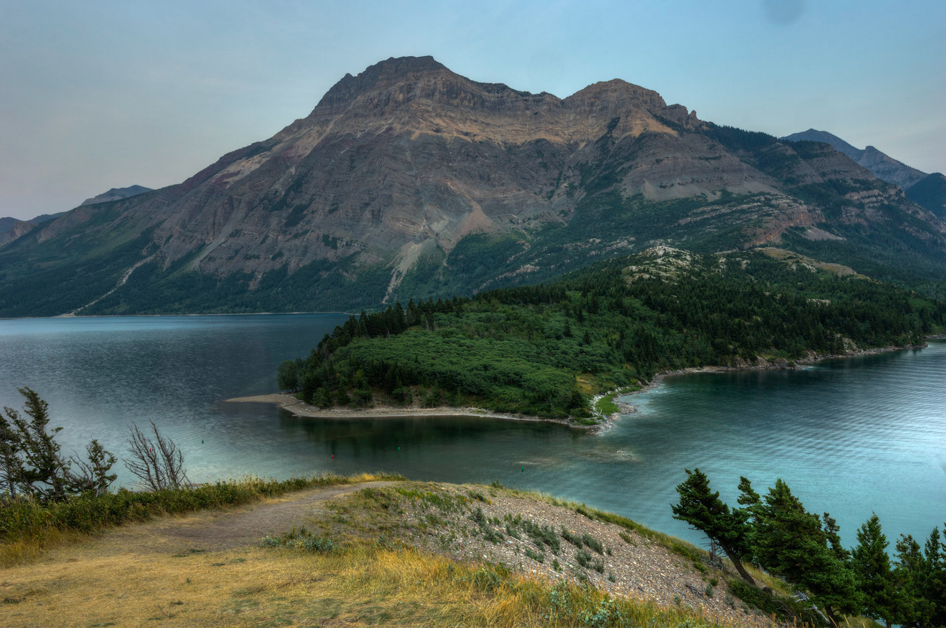 Mt. VImy above the strait connecting Middle and Upper Waterton Lakes.  From the hilltop of the Prince of Wales Hotel.Waterton Lakes National ParkAugust 2, 2015This is an HDR image consisting of 5 exposures merged in Photomatix Pro. Additional processing in Lightroom and Photoshop.PENTAX K-3, Sigma 18-35mm f/1.8 DC HSM ArtISO 100 21 mm  0.8 sec at ƒ / 11