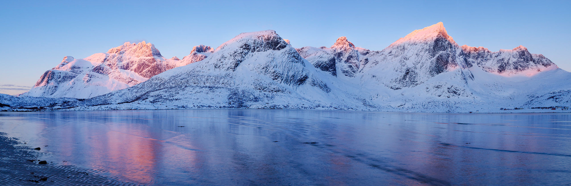 FIrst light on the mountains of Flakstadøya.Flakstad, Nordland, NorwayMarch 22, 2018This is a panoramic images consisting of 5 frames stitched in Photoshop. Additional processing in Lightroom and Photoshop.PENTAX K-1, HD PENTAX-D FA 24-70mm F2.8ED SDM WRISO 100 40 mm  0.3 sec at ƒ / 16