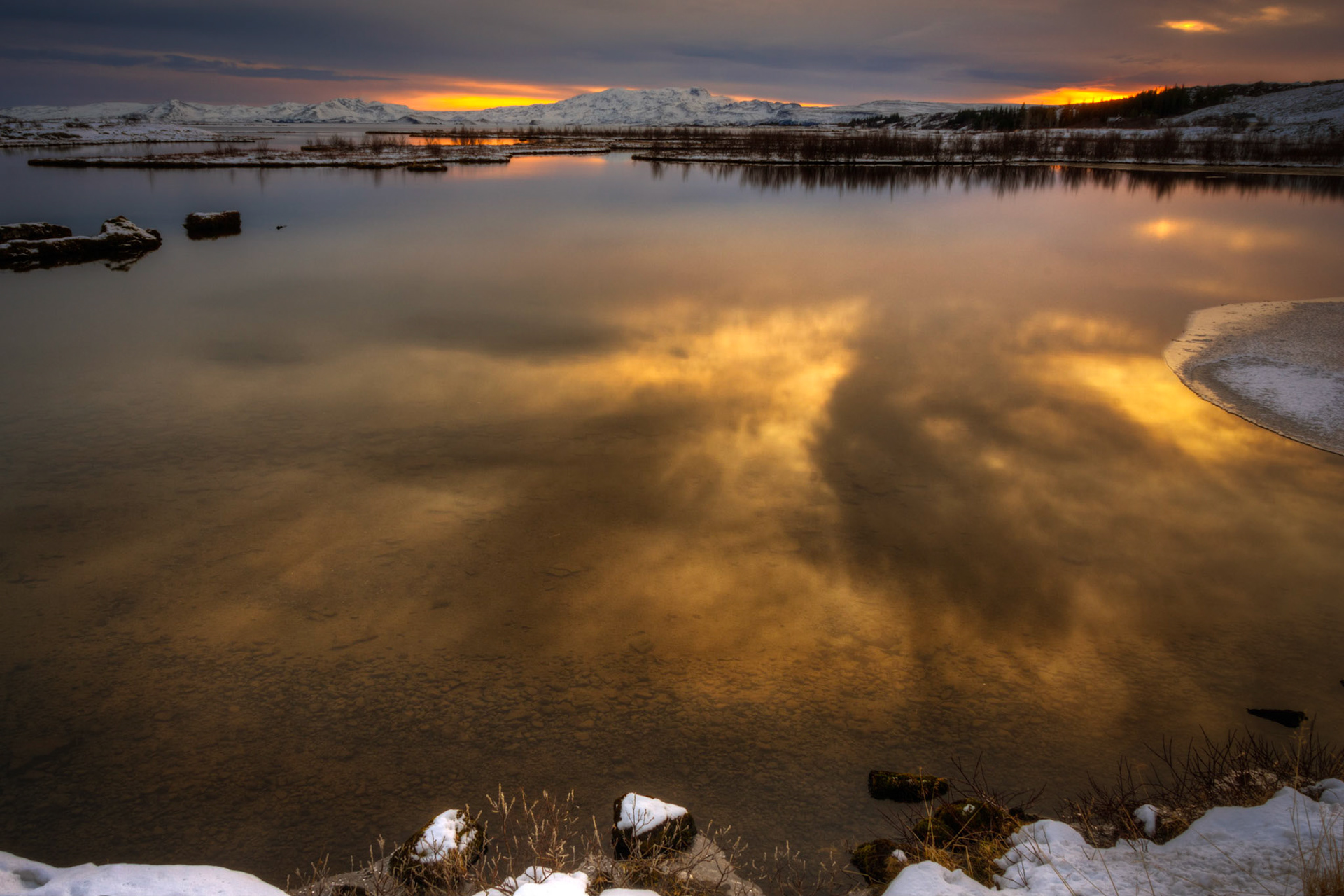 Sunset in Þingvellir National Park, near Silfra, in the rift between the North American and European tectonic plates.Þingvellir National ParkSuðerland, IcelandFebruary 7, 2016This is an HDR image consisting of 5 exposures merged in Photomatix Pro. Additional processing in Lightroom and Photoshop.PENTAX K-3, Sigma 18-250mm f/3.5-6.3 DC OS HSMISO 100 18 mm  ¼ sec at ƒ / 18
