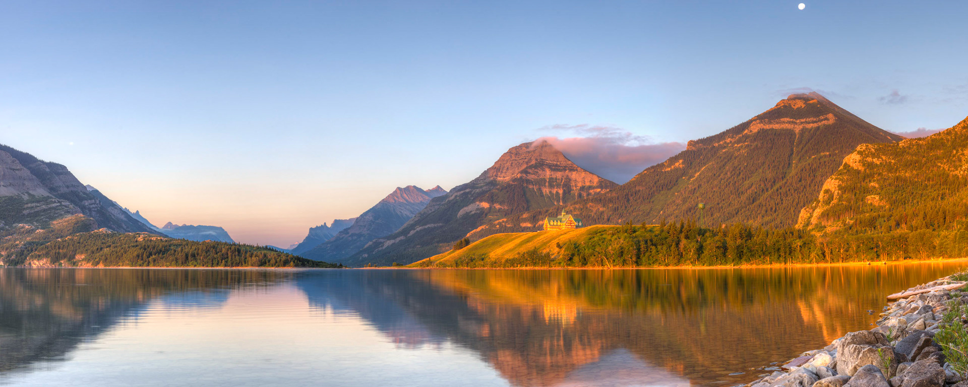 Sunrise at Middle Waterton Lake.Waterton Lakes National ParkAugust 2, 2015This is an HDR panoramic image consisting of 7 frames comprised of 5 exposures each. HDR processing performed in Photomatix Pro.  Panoramic stitching performed in Photoshop. Additional processing performed in Lightroom and Photoshop.PENTAX K-3, Sigma 18-35mm f/1.8 DC HSM ArtISO 100 31 mm  0.5 sec at ƒ / 16