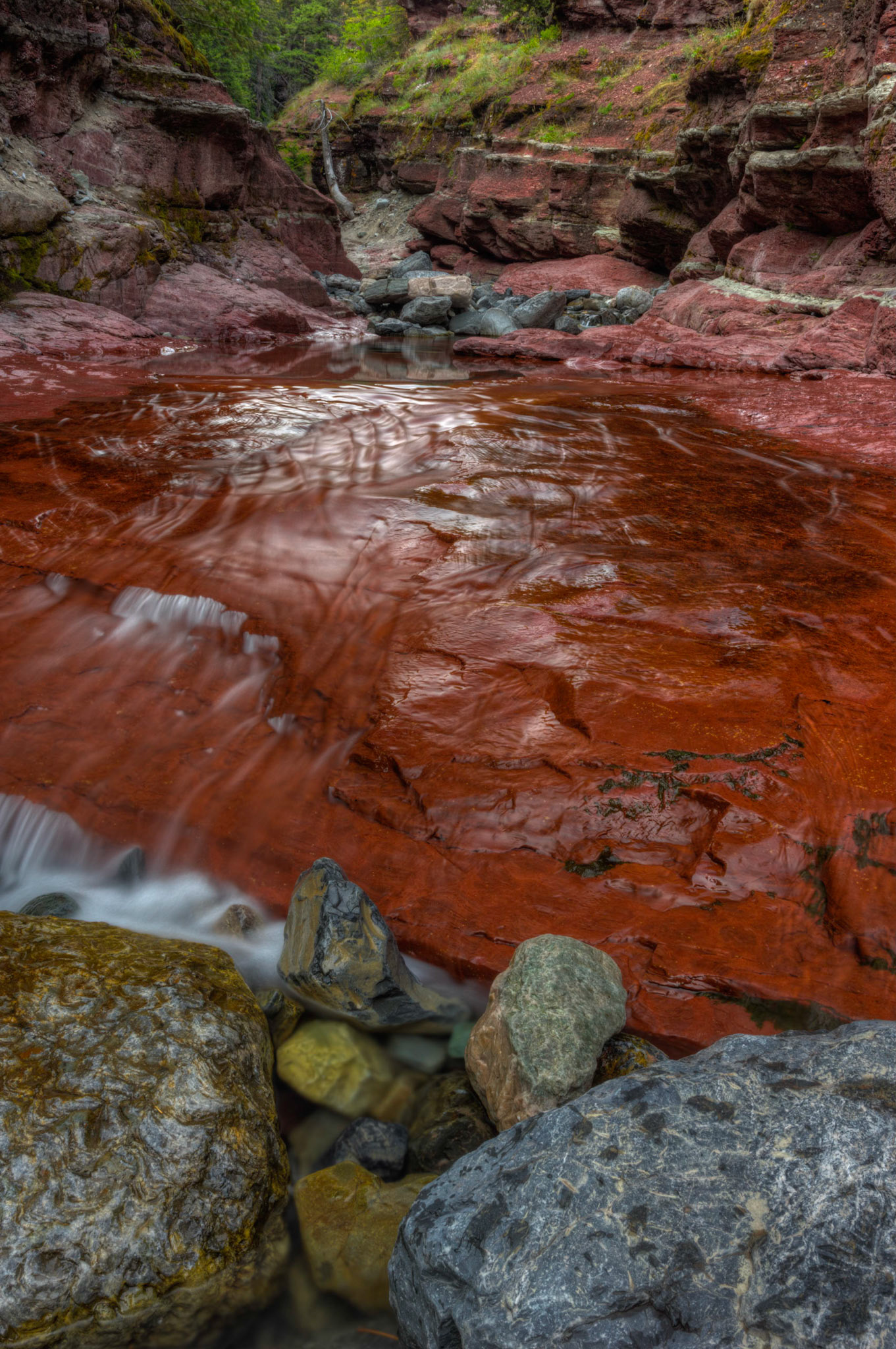 Red Rock CanyonWaterton Lakes National ParkAugust 2, 2015This is an HDR image consisting of 5 exposures merged in Photomatix Pro. Additional processing in Lightroom and Photoshop.PENTAX K-3, Sigma 18-35mm f/1.8 DC HSM ArtISO 100 21 mm  1.6 sec at ƒ / 16