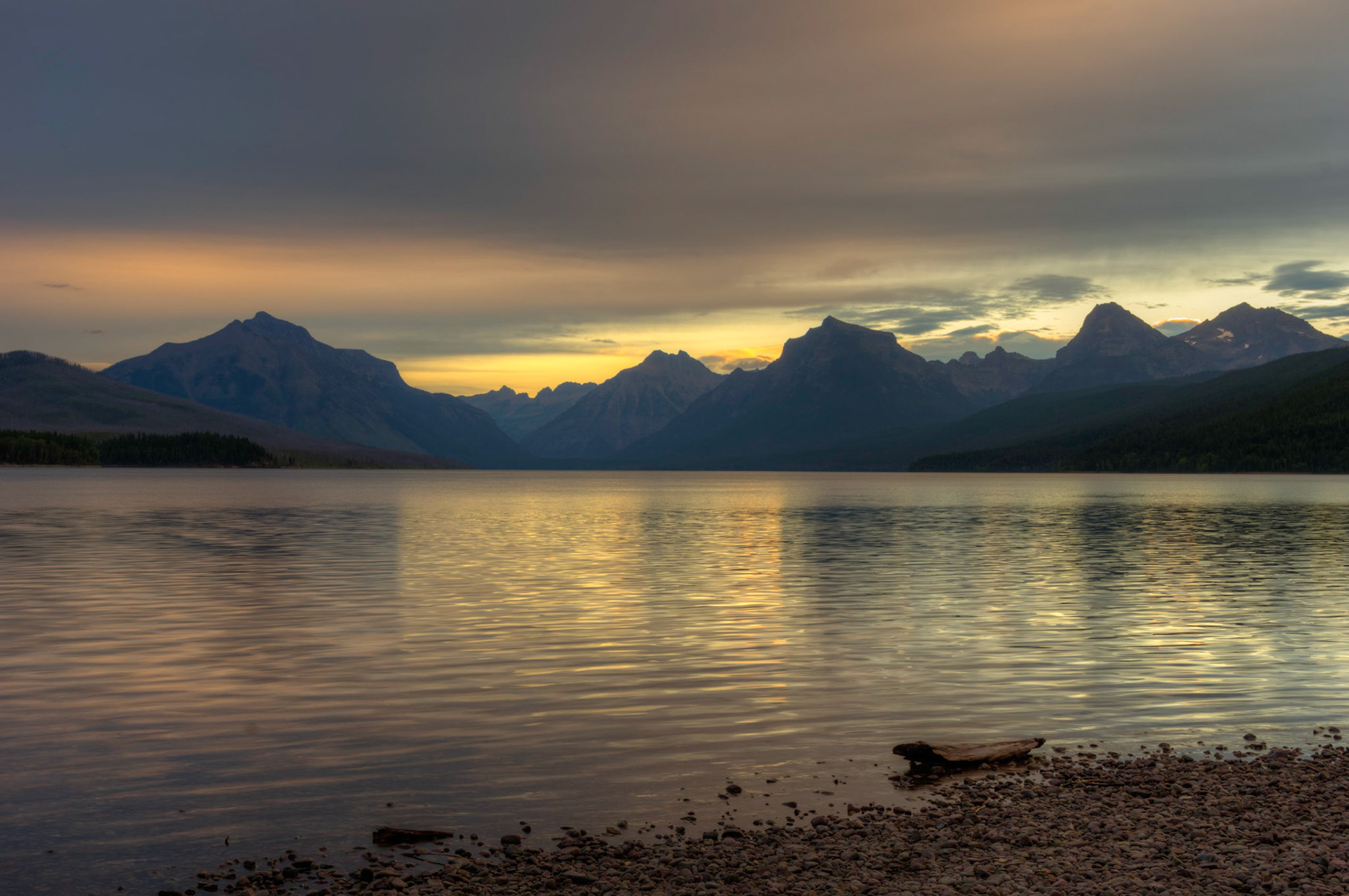 Sunrise at Lake McDonald, at Apgar Village.Glacier National ParkJuly 27, 2015This is an HDR image consisting of 5 exposures merged in Photomatix Pro. Additional processing in Lightroom and Photoshop.PENTAX K-3, Sigma 18-250mm f/3.5-6.3 DC OS HSMISO 100 28 mm  0.3 sec at ƒ / 11