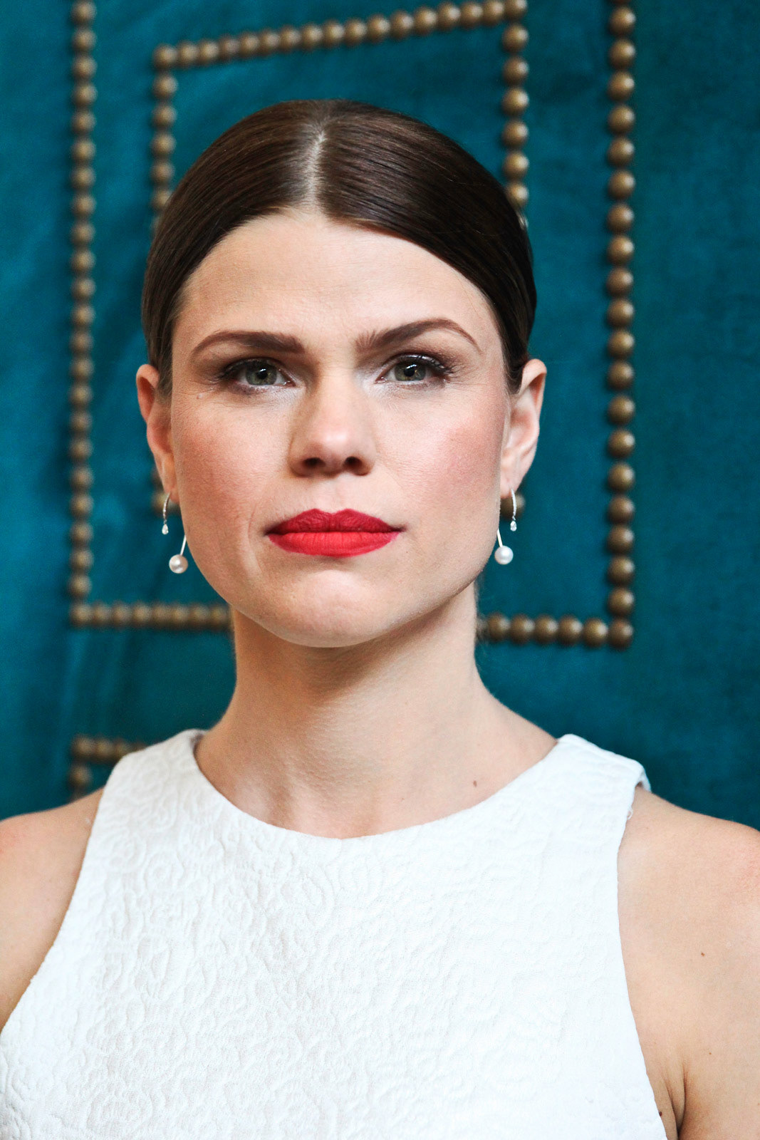 Striking portrait of bride with red lipstick on a blue velvet background