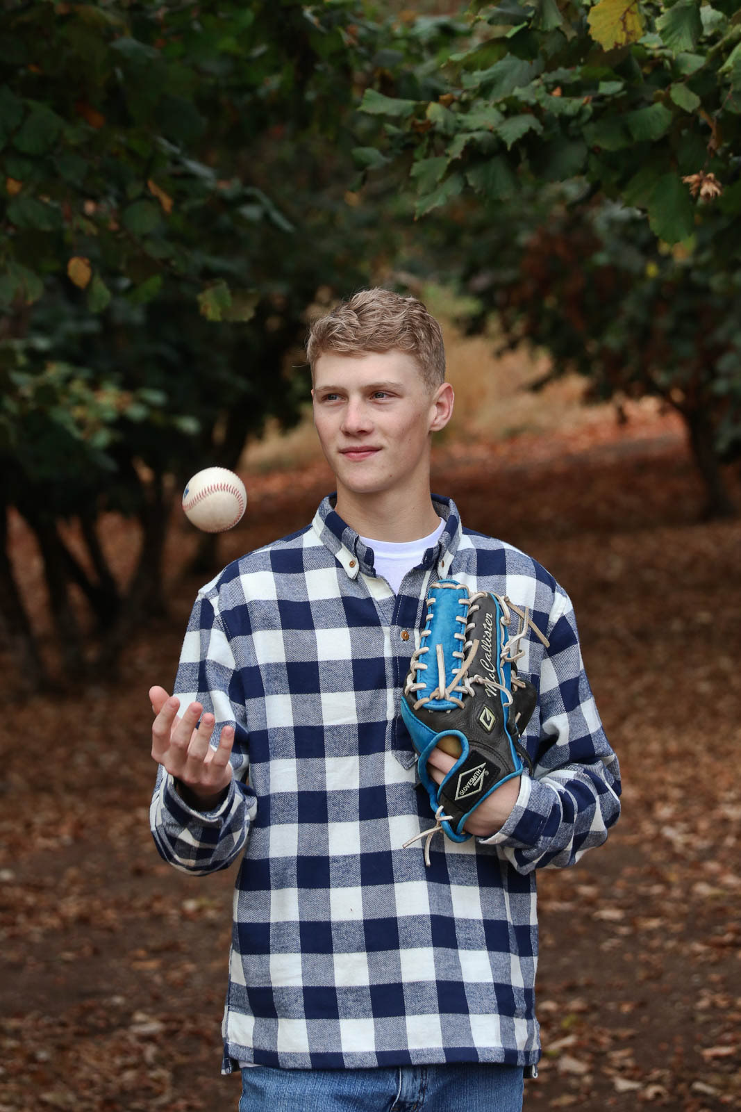 Teenage boy throws a baseball