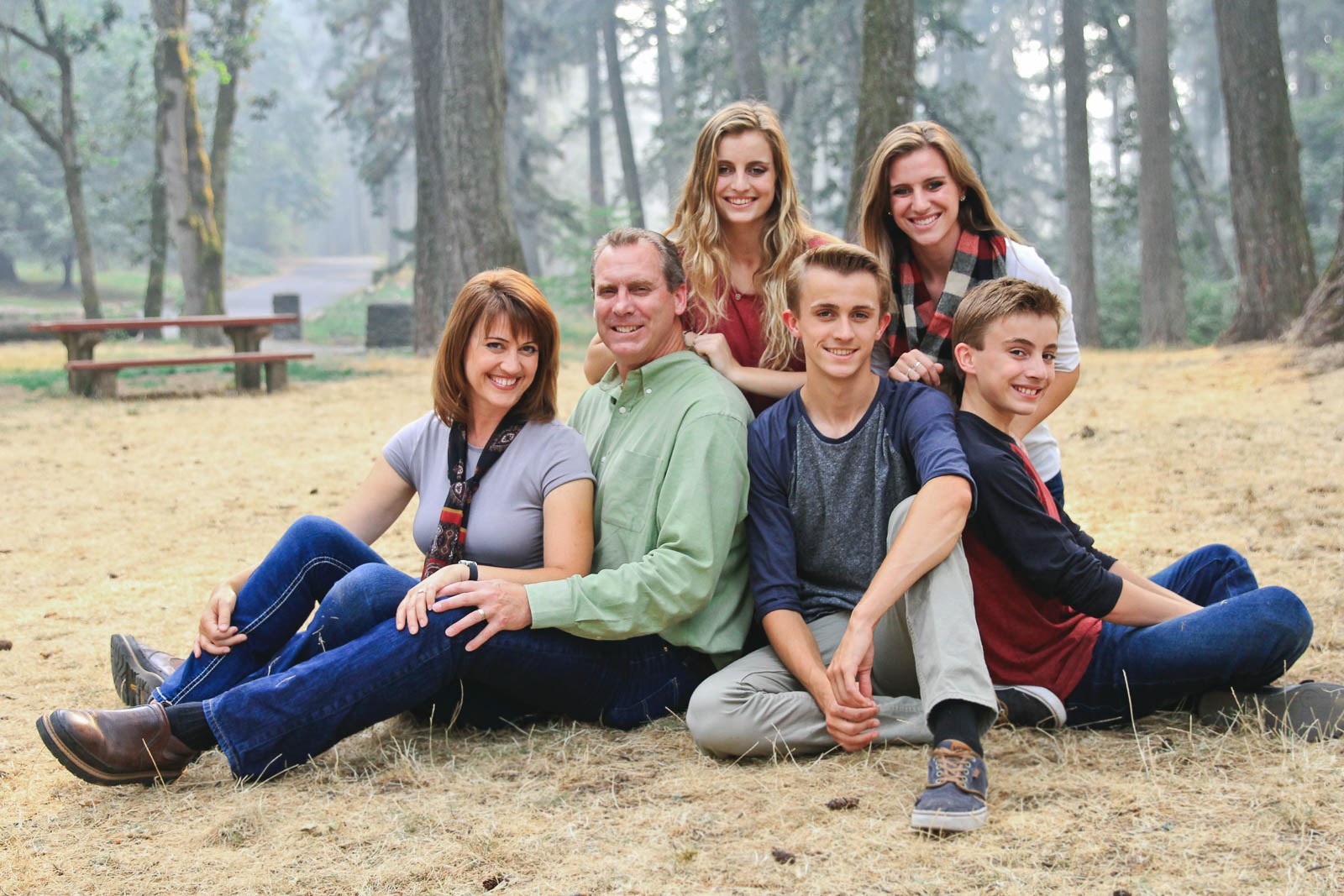 Portrait photo shoot for the whole family, all sitting in the grass together