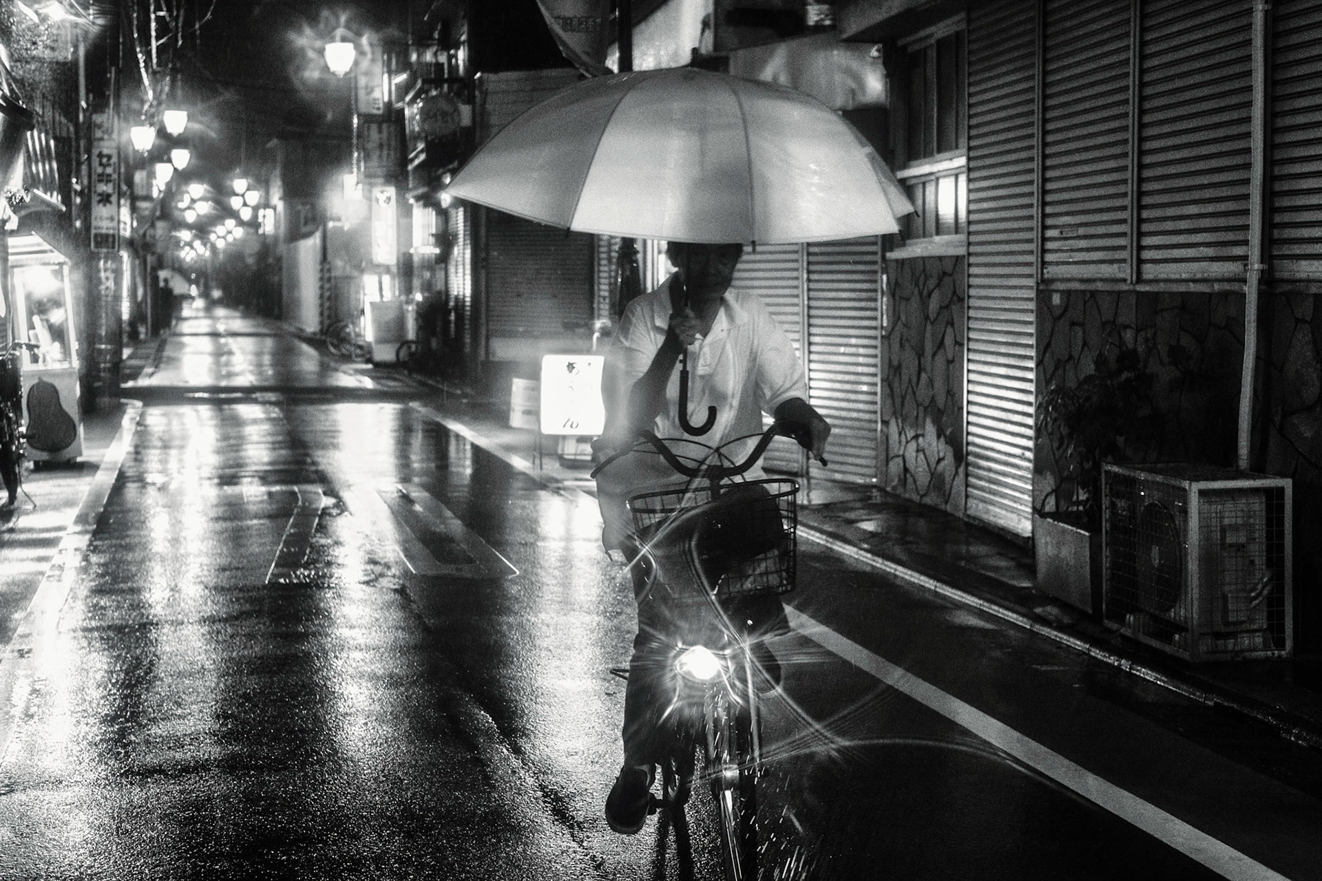 Typhoon means rain. Lots of rain. Yesterday one typhoon just touched Tokyo. Some companies ordered their workers to go home. 
But for some, typhoon meant nothing but business as usual.

A cyclist holding an umbrella in Nakano-ku, Tokyo, Japan.

The ability to ride a bicycle in heavy rain with an umbrella in one hand was always something that surprised me on Japanese streets.This view is very common in Kansai, however, Kanto is not much behind.

#Tokyo, #Japan, #daily, #documentary, #typhoon, #bicycle, #umbrella, #japan_night_view, #night #instagram_japan, #fujifeed,  #fujixlovers #streetclassics #discovertokyo #art_of_japan_ #traveling_night, #tokyocameraclub #bestphoto_japan #bestjapanpics #super_asia_channel #bestphoto_japan #lovers_nippon #nightcaptures #nightphotography #japan_night_view #super_night_channel #night_club  #night_gram