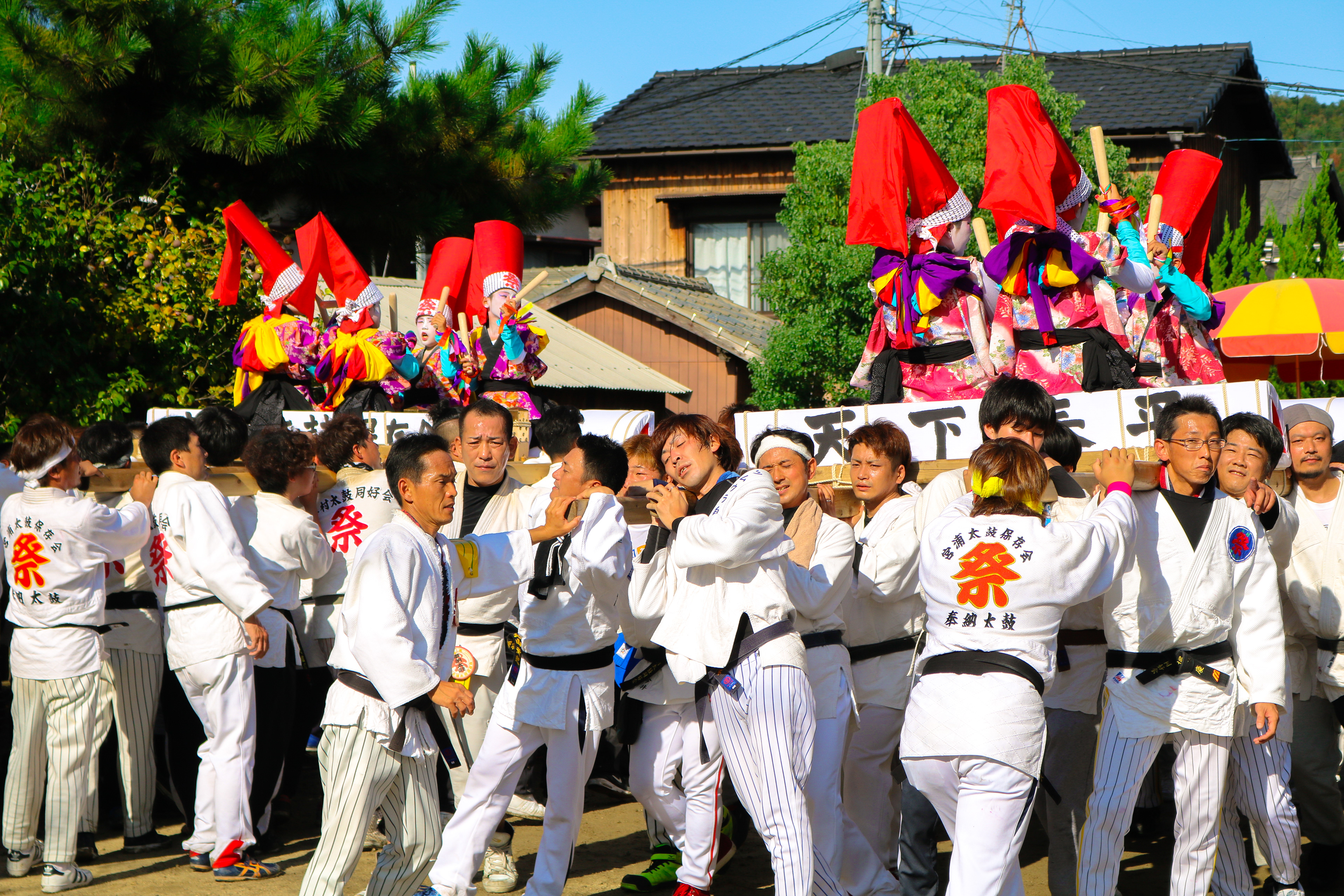 Residents carry children playing drums on mikoshi, Japan, 2017