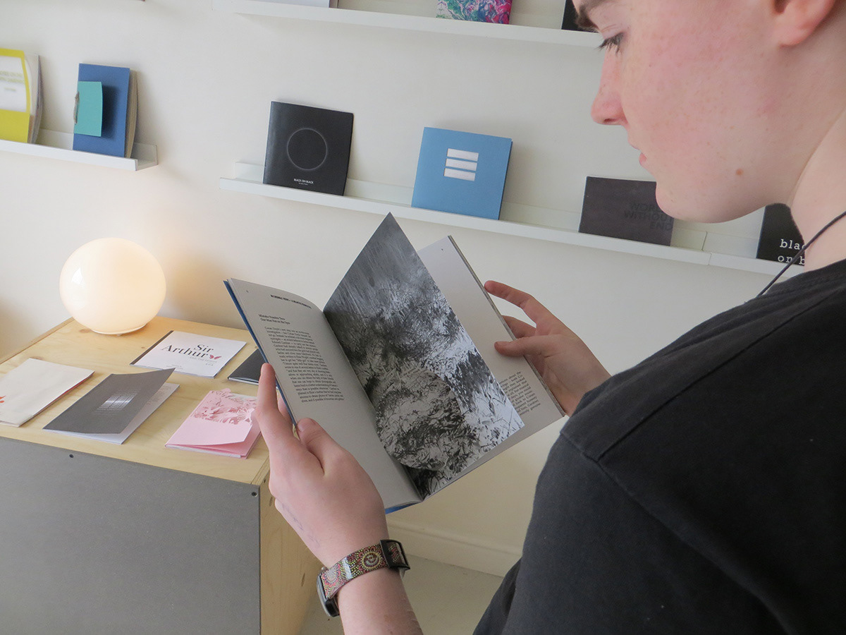 Person holding book at exhibition