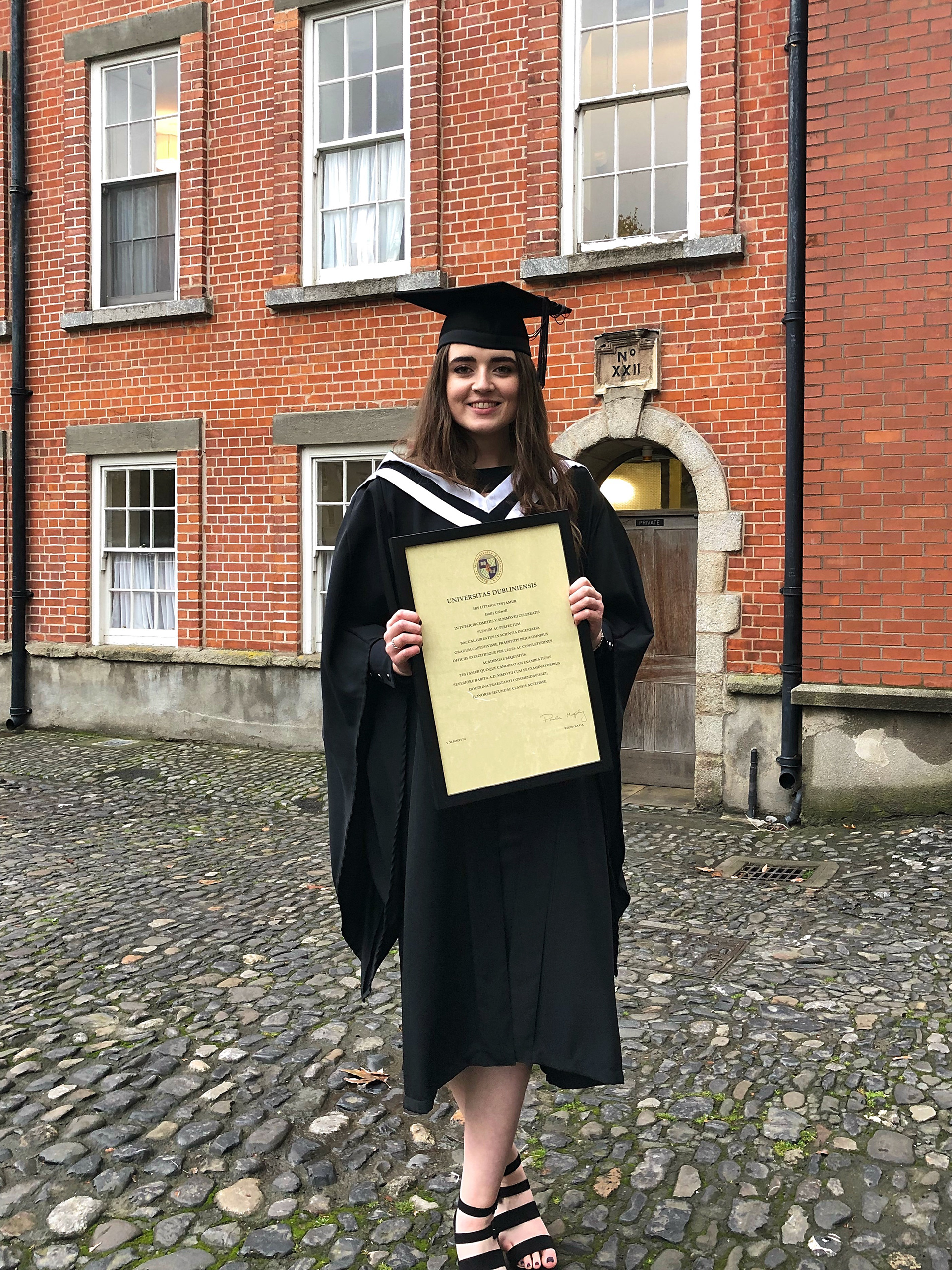 Emily Colwell in Trinity College Dublin holding BSc Engineering with Management Degree